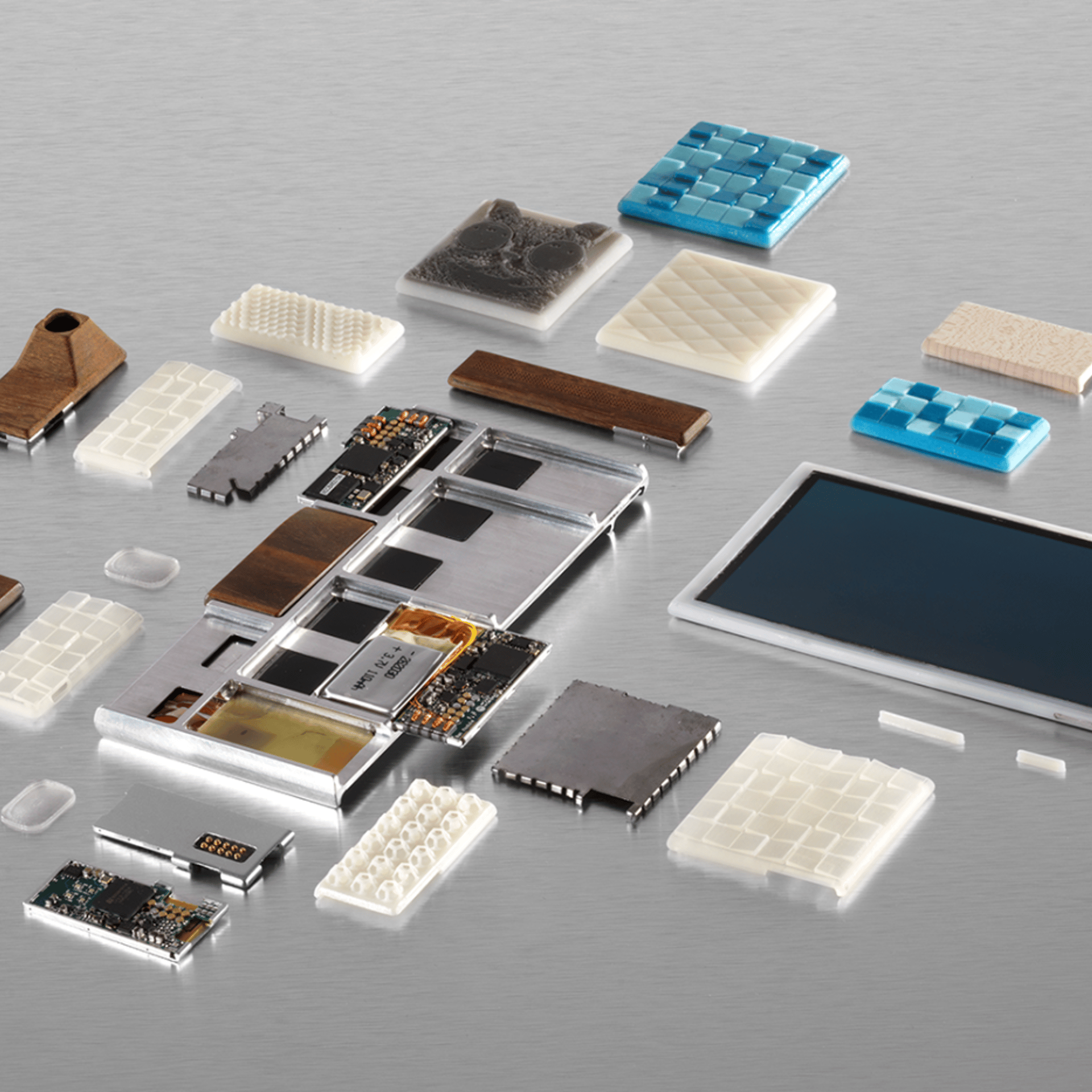 Parts of a functional prototype of a Project Ara phone -- still a work in progress -- including the endoskeleton frame, the screen, electrical components and custom 3D-printed module enclosures.