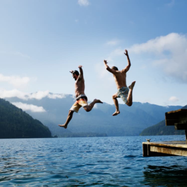 men-jumping-into-water