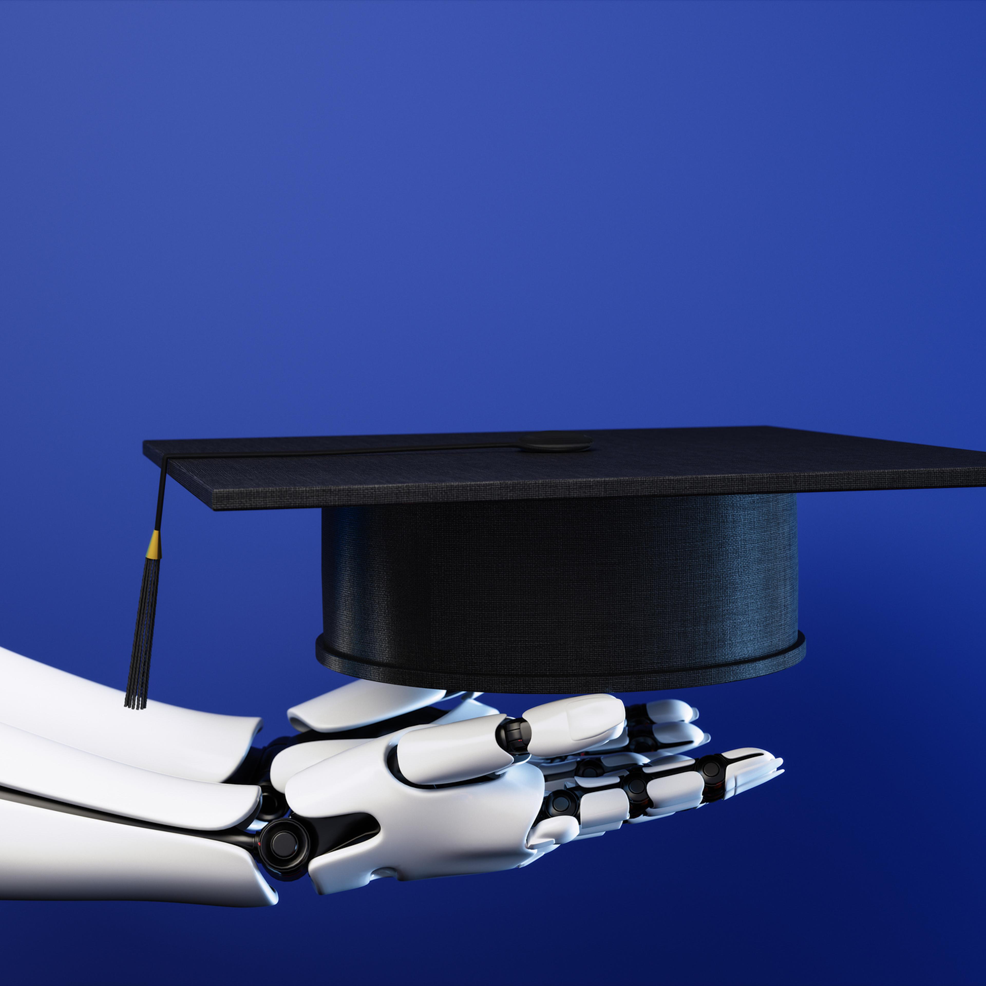 Side View Of Robot Hand Holding Graduation Cap