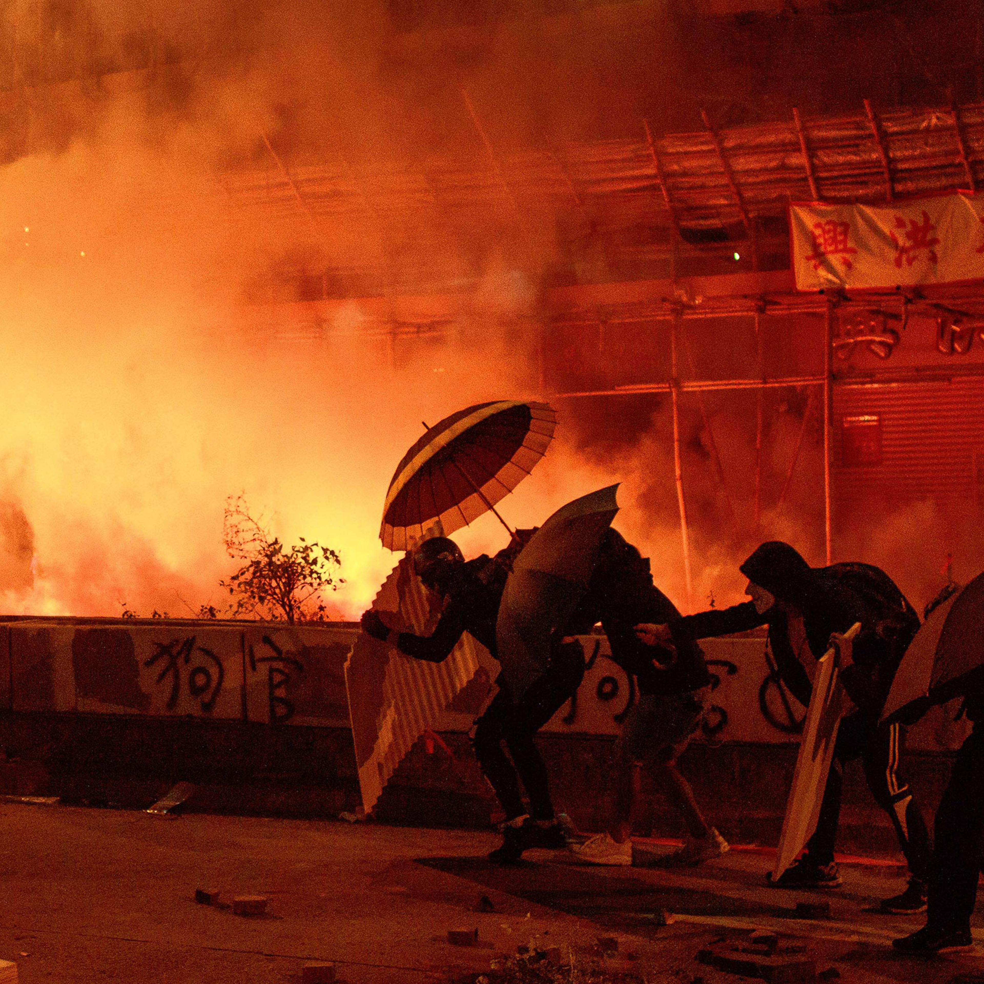 Protestors attempting tp reach Hong Kong Polytechnic University on Nov. 18 ace off against police