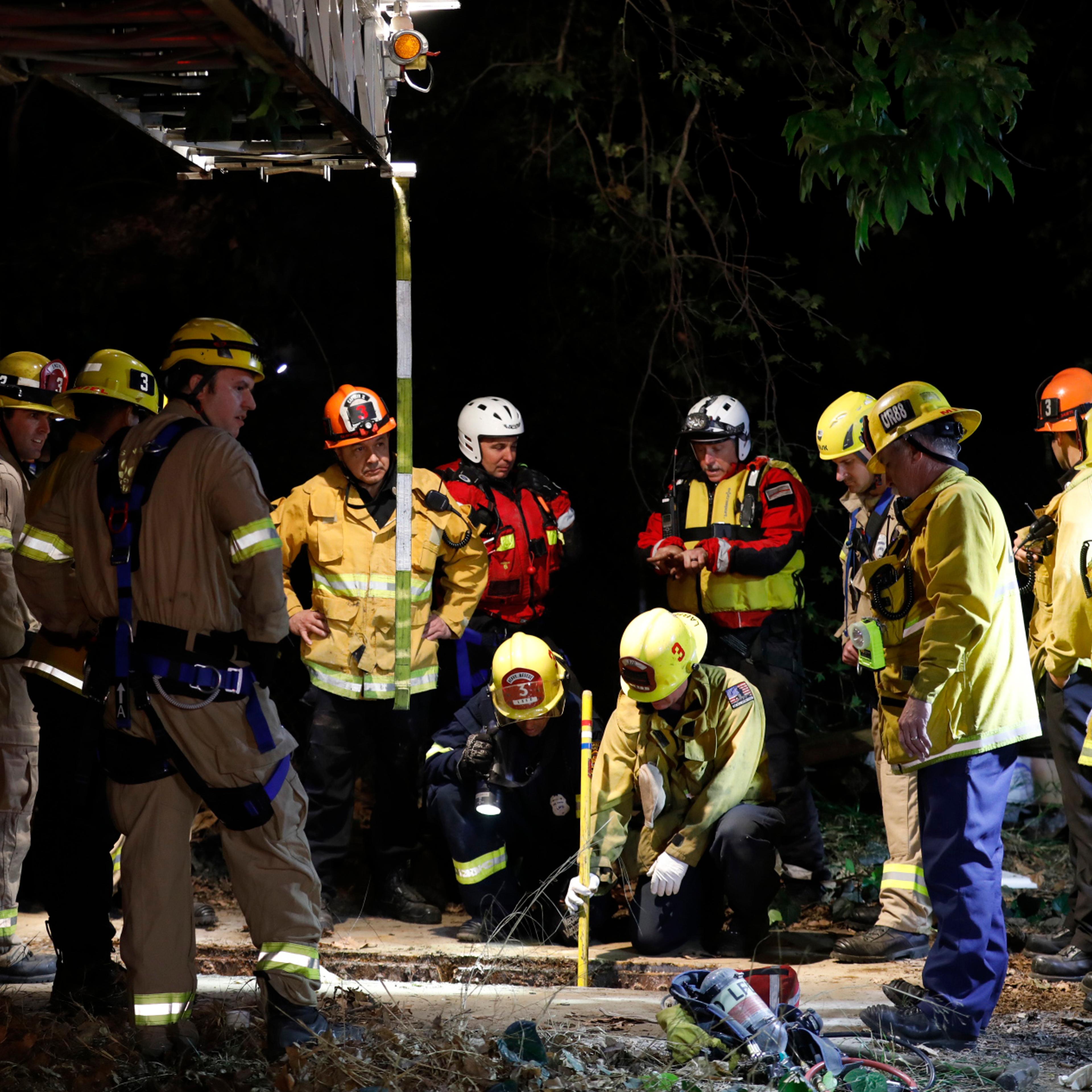 Los Angeles firefighters search for 13-year-old Jesse Hernandez after he fell into a sewage system