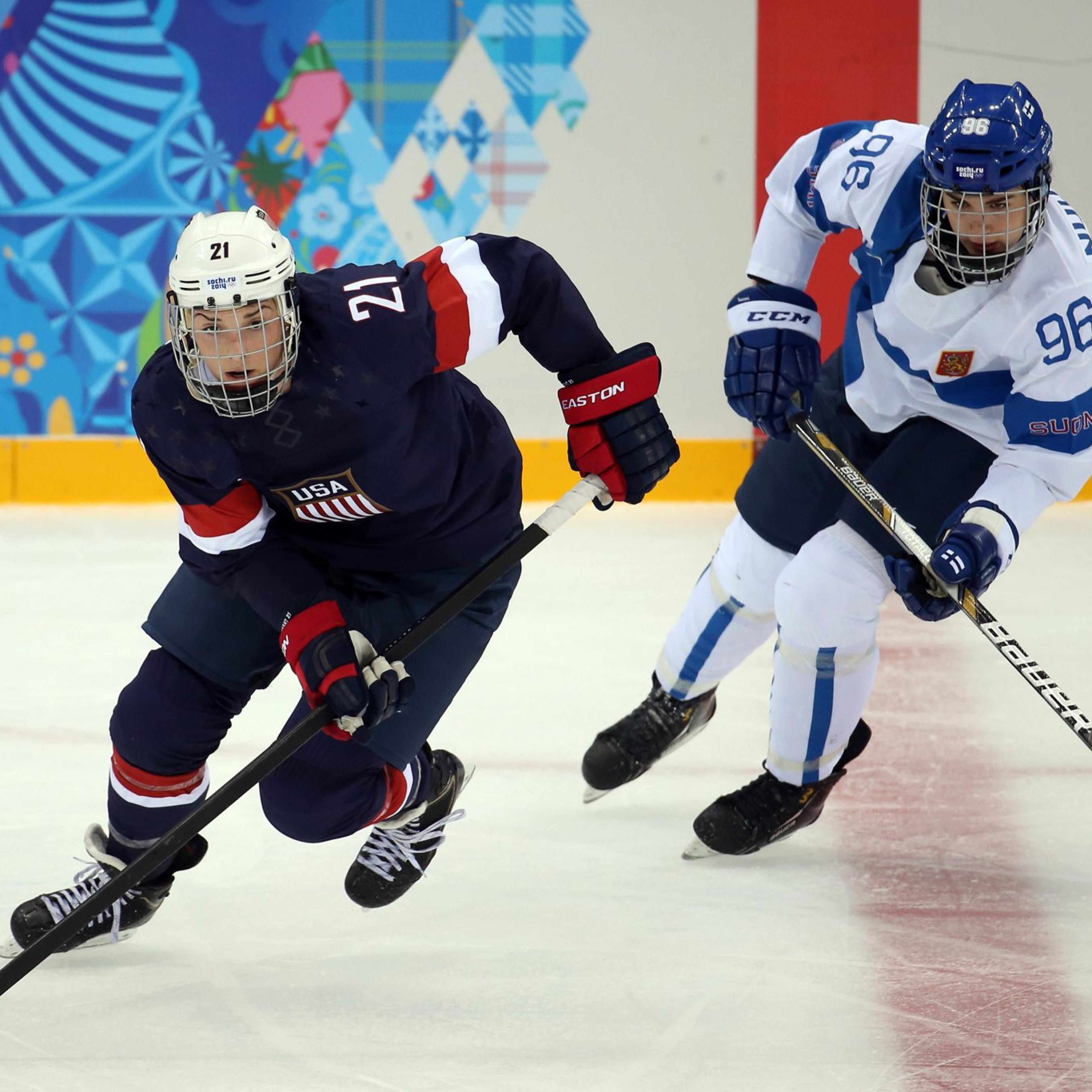 From left: U.S. forward Hilary Knight (21) skates ahead of Finland's Emma Nuutinen (96) during the second period in a women's hockey game at the 2014 Winter Olympics in Sochi, on Feb. 8, 2014.