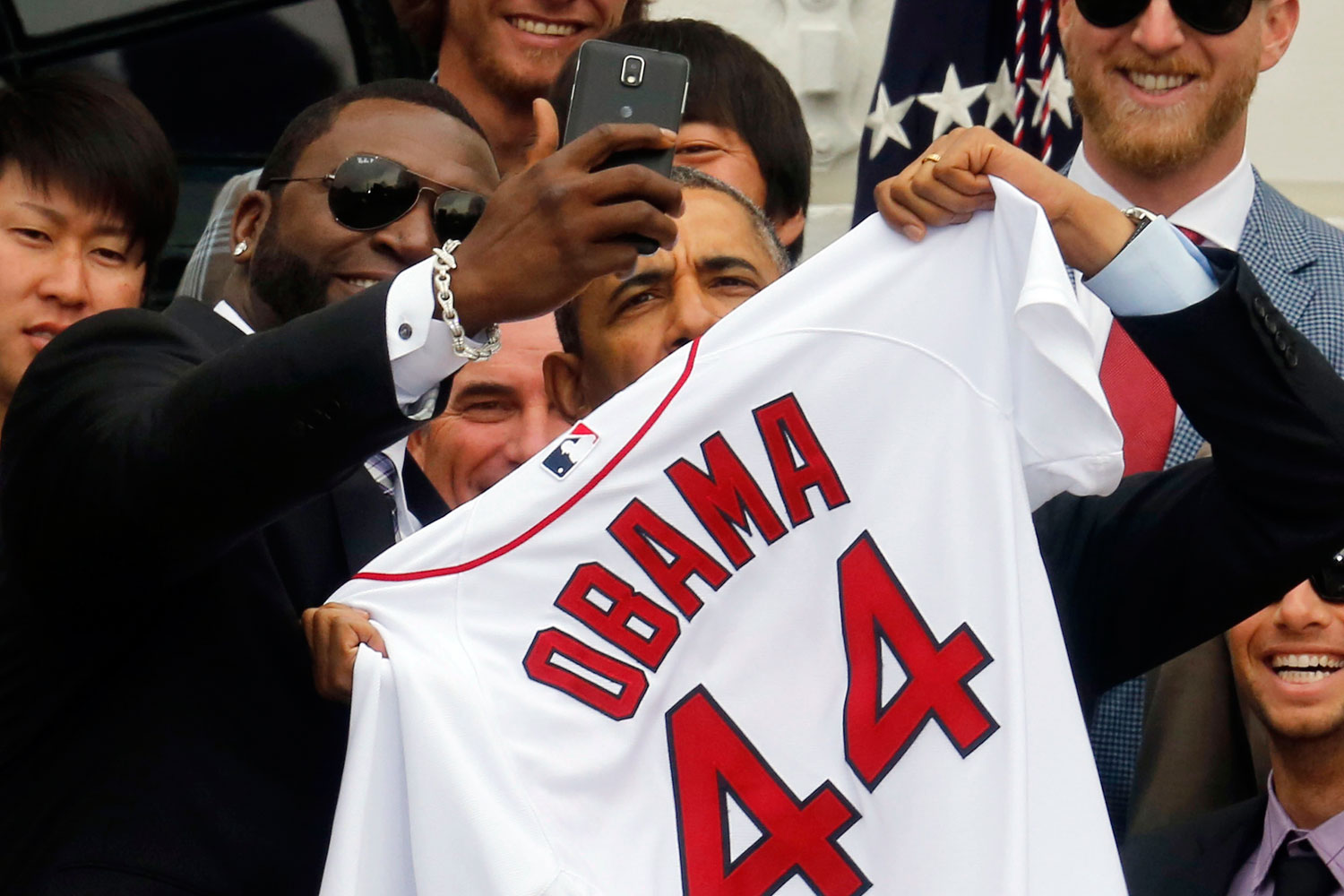 U.S. President Barack Obama poses with star player David Ortiz for a "selfie" as he welcomes the 2013 World Series Champion Boston Red Sox to the South Lawn of the White House in Washington, April 1, 2014. 