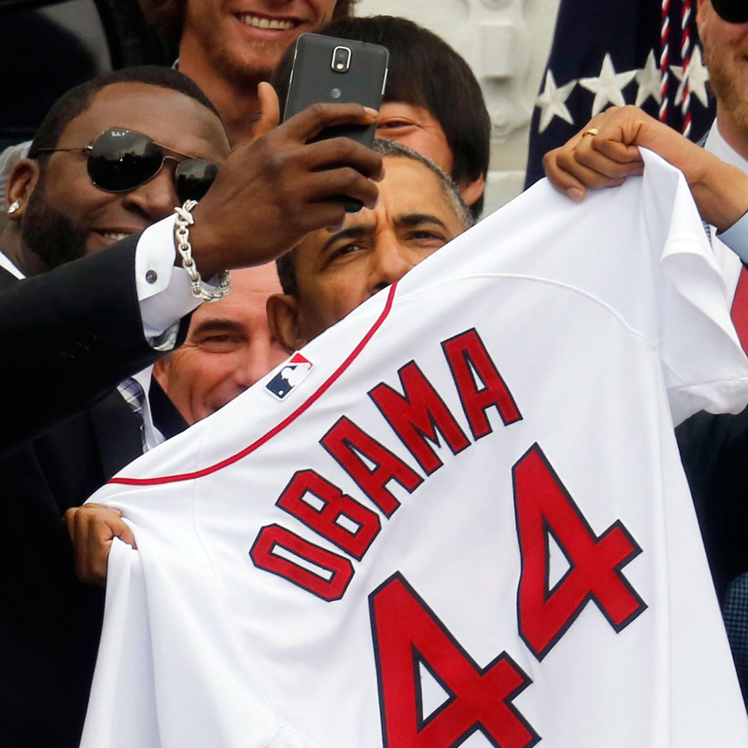 U.S. President Barack Obama poses with star player David Ortiz for a "selfie" as he welcomes the 2013 World Series Champion Boston Red Sox to the South Lawn of the White House in Washington, April 1, 2014.
