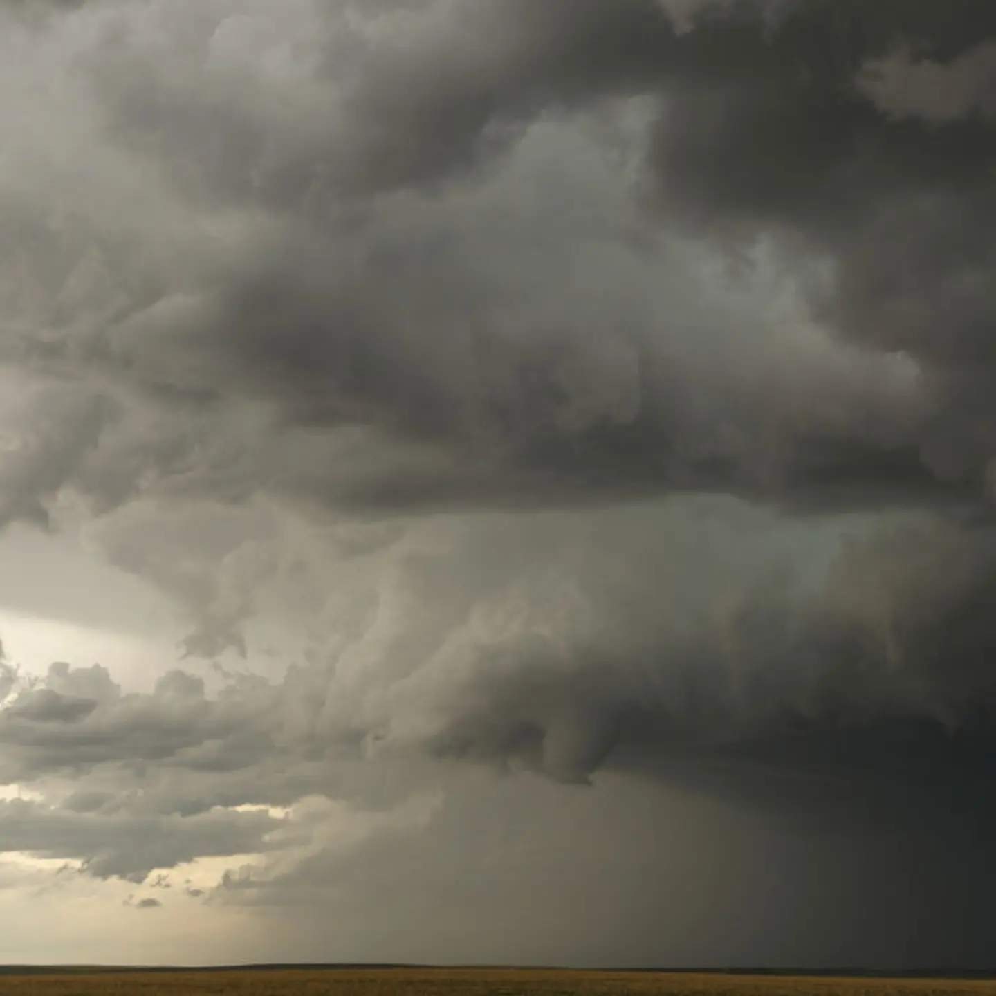A small funnel cloud forms in the distance during a supercell thunderstorm, May 8, 2017 in Elbert County, Colorado.