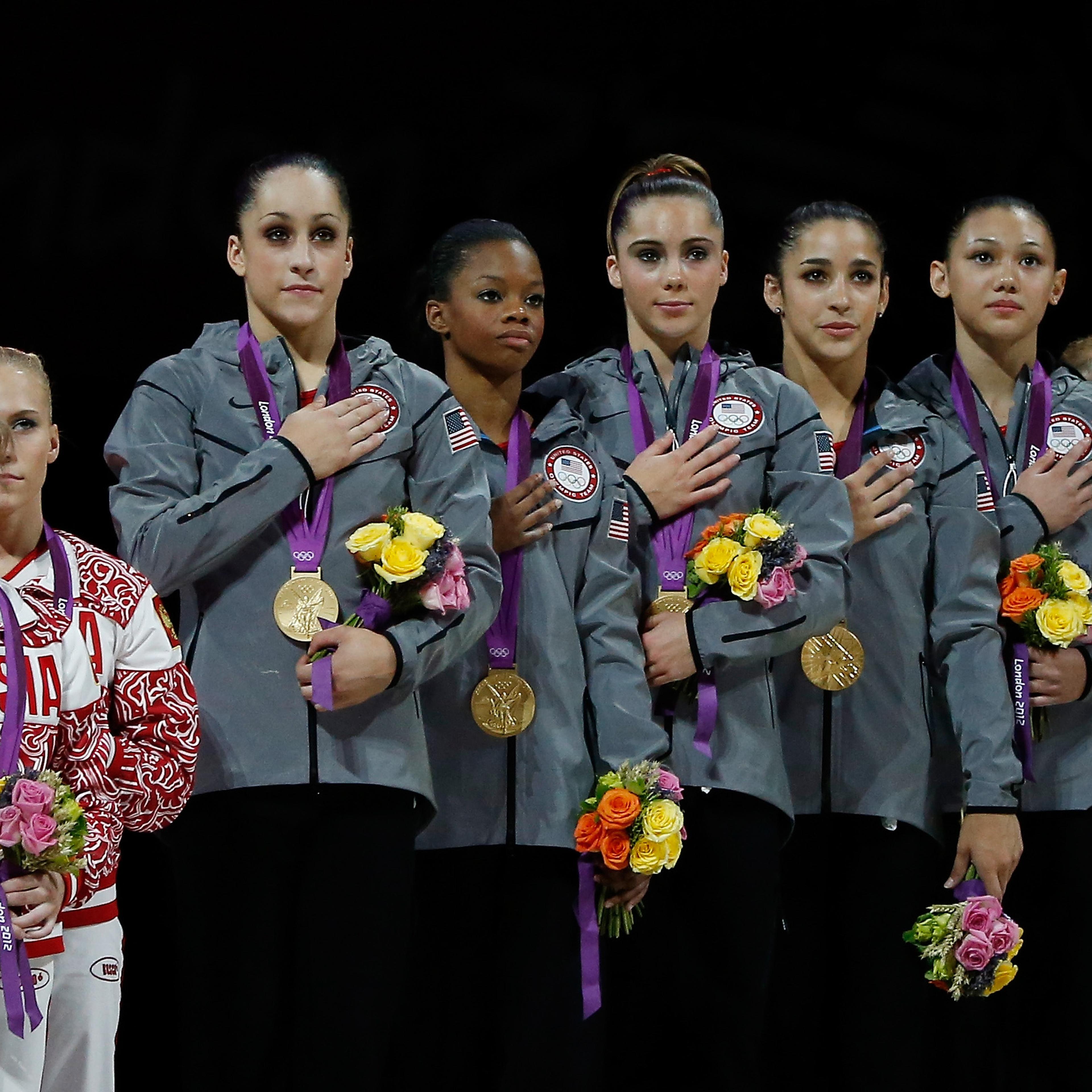 Silver medalists Russia, gold medalists United States and bronze medalists Romania pose of the podium after the Artistic Gymnastics Women's Team final on Day 4 of the London 2012 Olympic Games at North Greenwich Arena on July 31, 2012 in London.