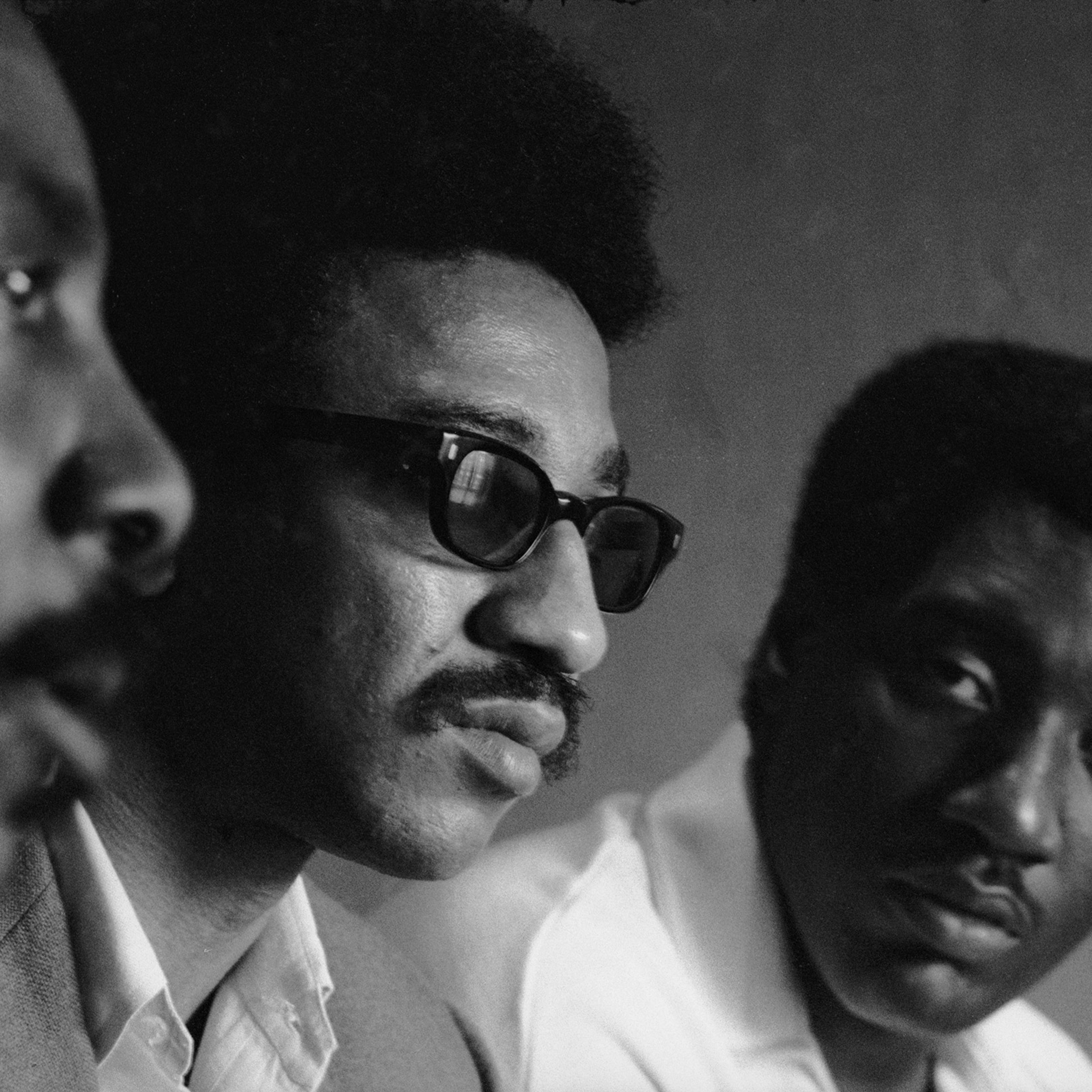 Civil rights activist Dick Gregory, left, and musician Otis Redding flank H. Rap Brown at an August 1967 convention in Atlanta