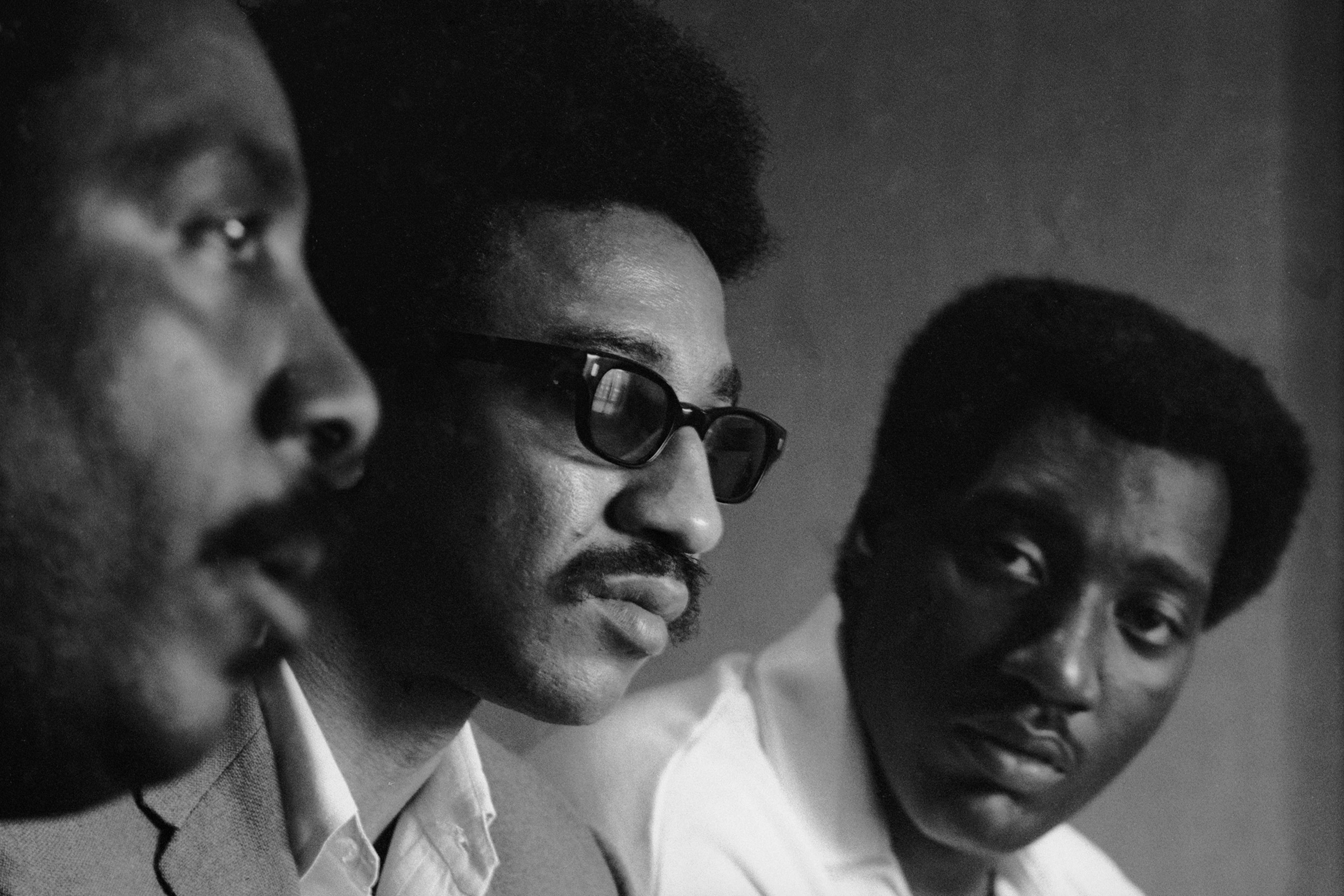 Civil rights activist Dick Gregory, left, and musician Otis Redding flank H. Rap Brown at an August 1967 convention in Atlanta