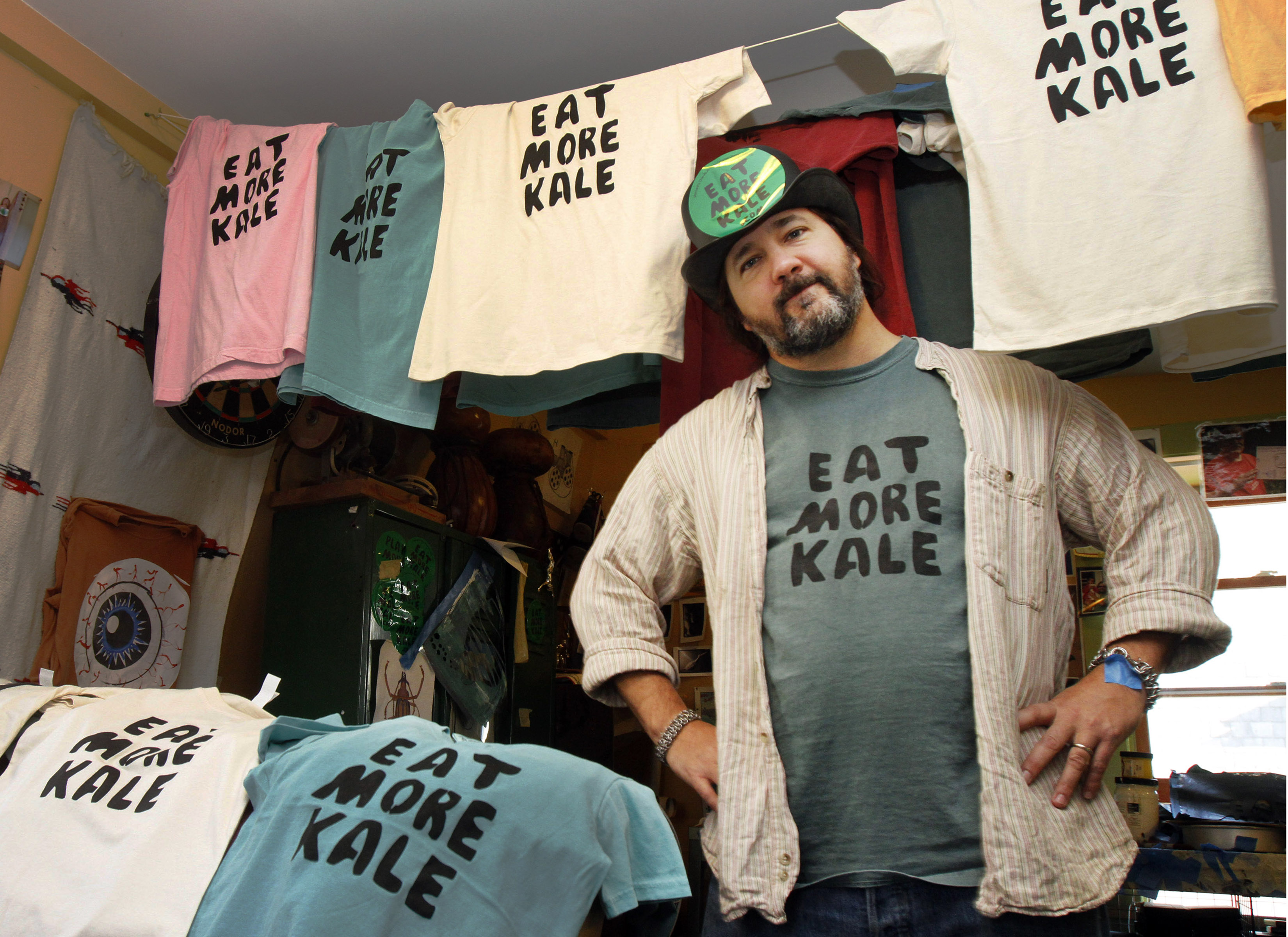 Bo Muller-Moore stands in his home studio in Montpelier, Vt. Muller-Moore, the Vermont man who is building a business around the term "eat more kale," which has been plastered on T-shirts, bumper stickers and other items, is running into opposition from 