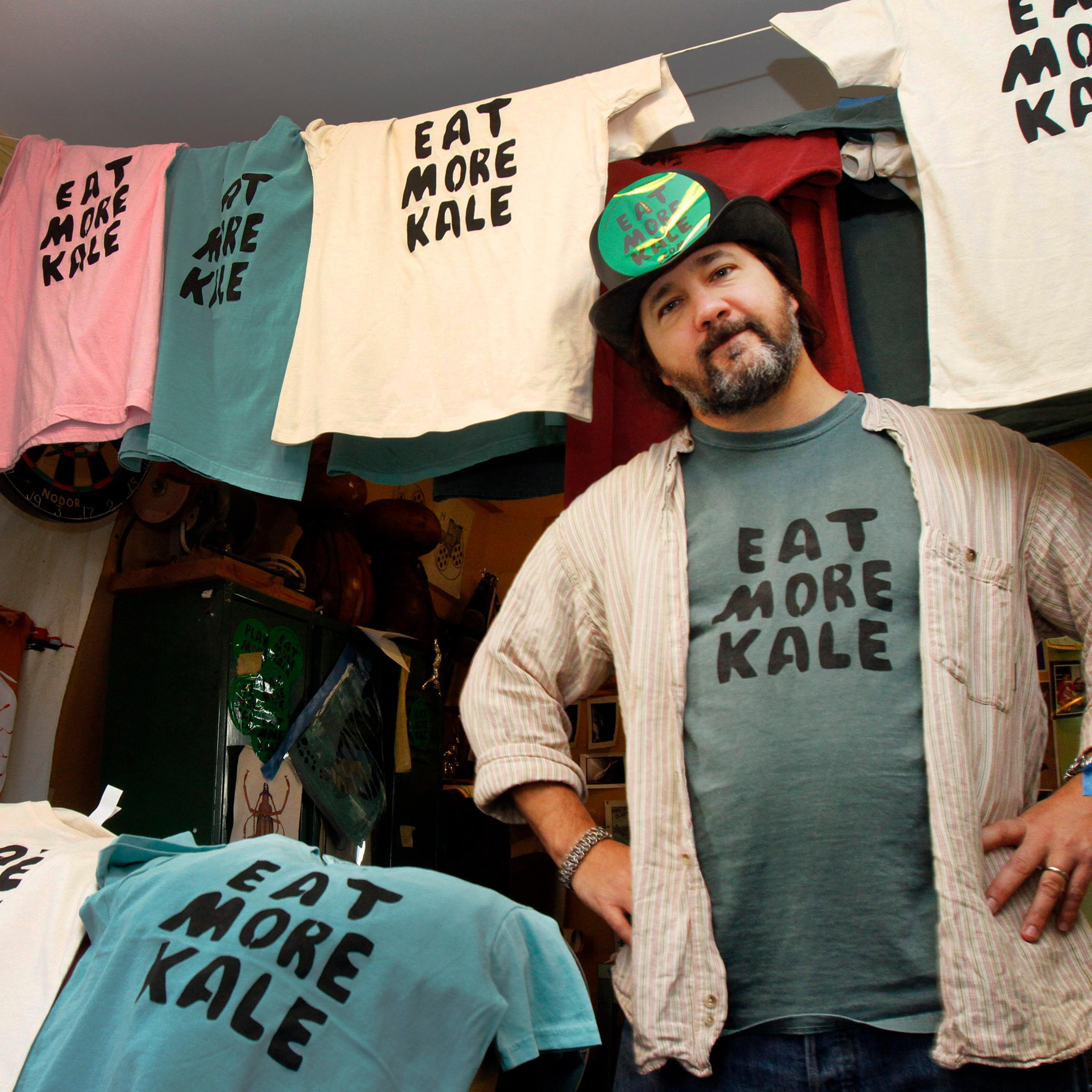 Bo Muller-Moore stands in his home studio in Montpelier, Vt. Muller-Moore, the Vermont man who is building a business around the term "eat more kale," which has been plastered on T-shirts, bumper stickers and other items, is running into opposition from