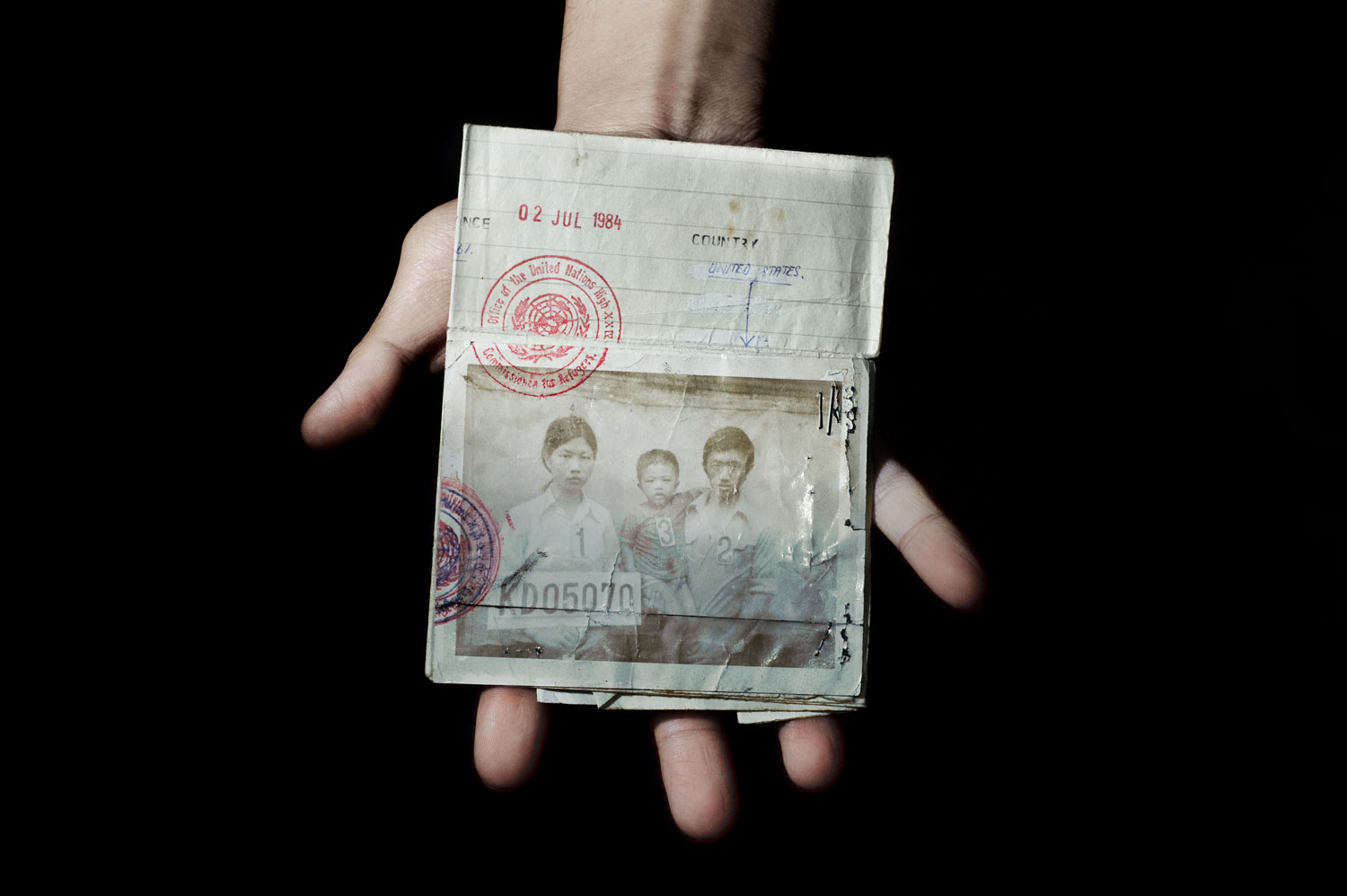 Bronx, New York City, September 2011. <br><br>Sonny Vaahn, 25, holds the refugee identification card of his family members, which was given upon initial entry into a refugee camp along the Thai-Cambodian border following the end of the Killing Fields in Cambodia.