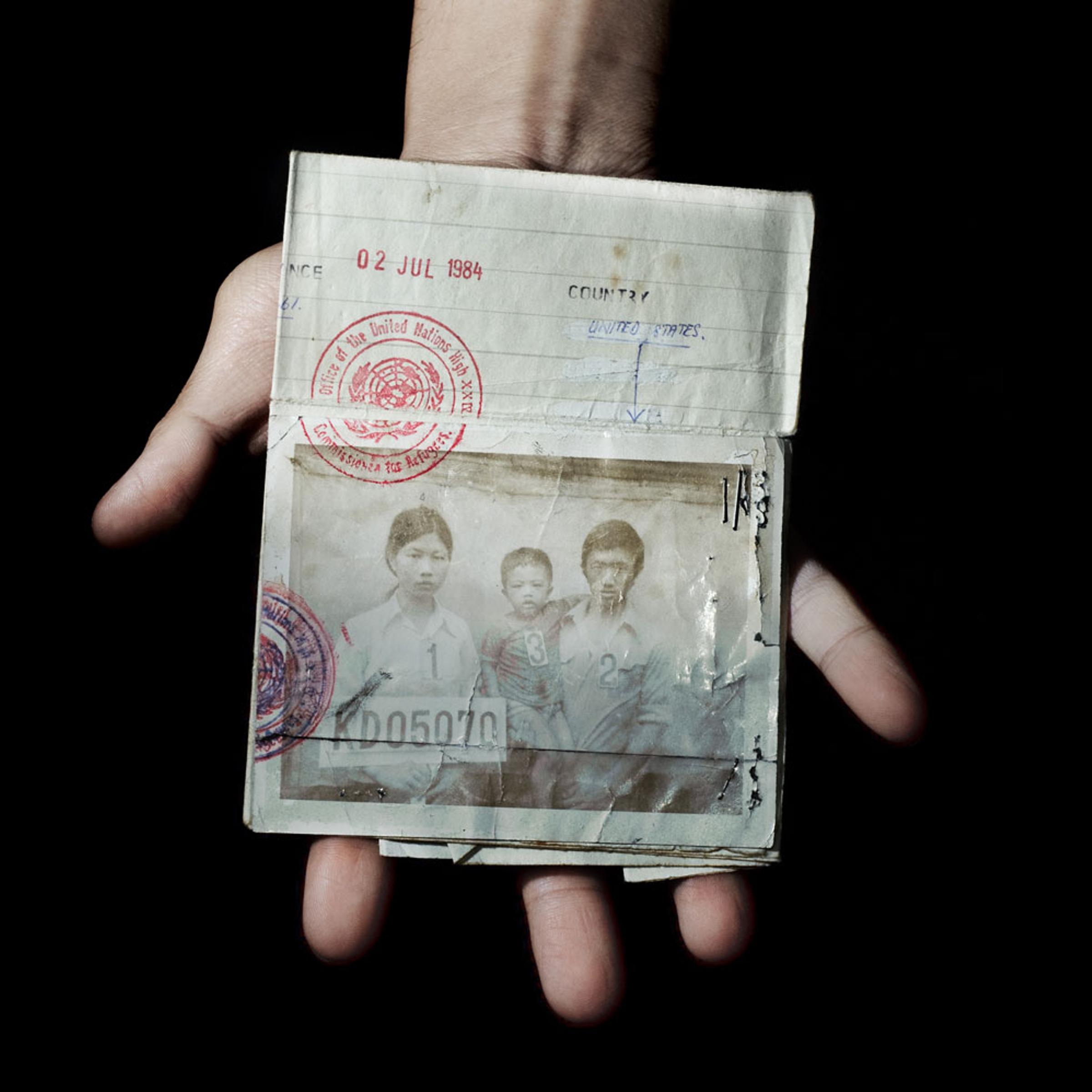 Bronx, New York City, September 2011. <br><br>Sonny Vaahn, 25, holds the refugee identification card of his family members, which was given upon initial entry into a refugee camp along the Thai-Cambodian border following the end of the Killing Fields in Cambodia.