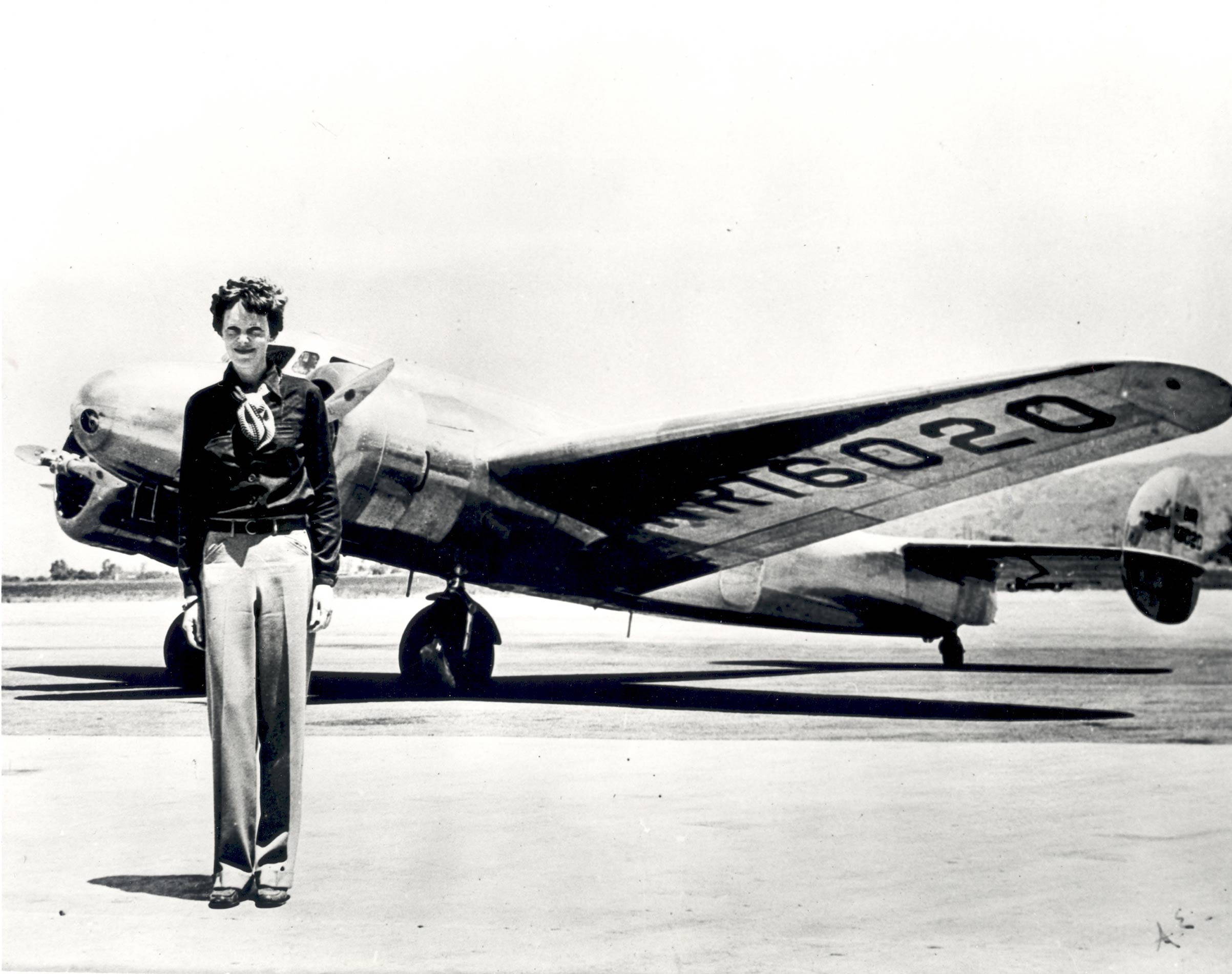 A circa 1937 photo of Amelia Earhart standing in front of the Lockheed Electra she flew when she disappeared that year.