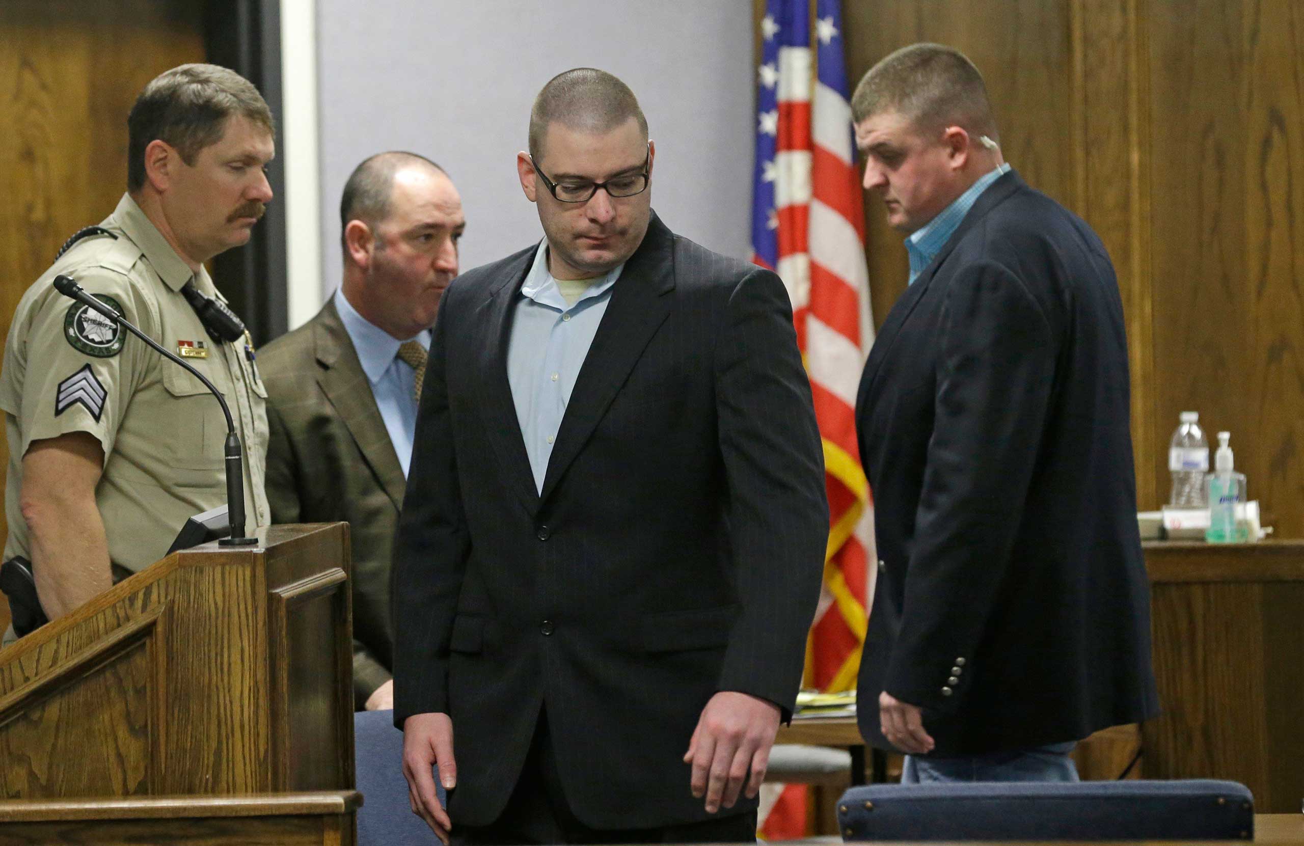 Eddie Ray Routh, 27, takes his seat with law enforcement officers a pretrial motion hearing in Stephenville, Texas Feb. 10, 2015.