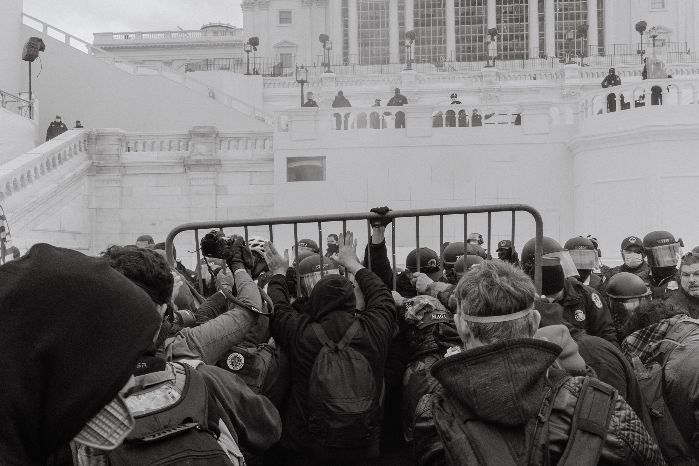 Pro-Trump rioters attempt to move a barricade outside of the U.S. Capitol in Washington.