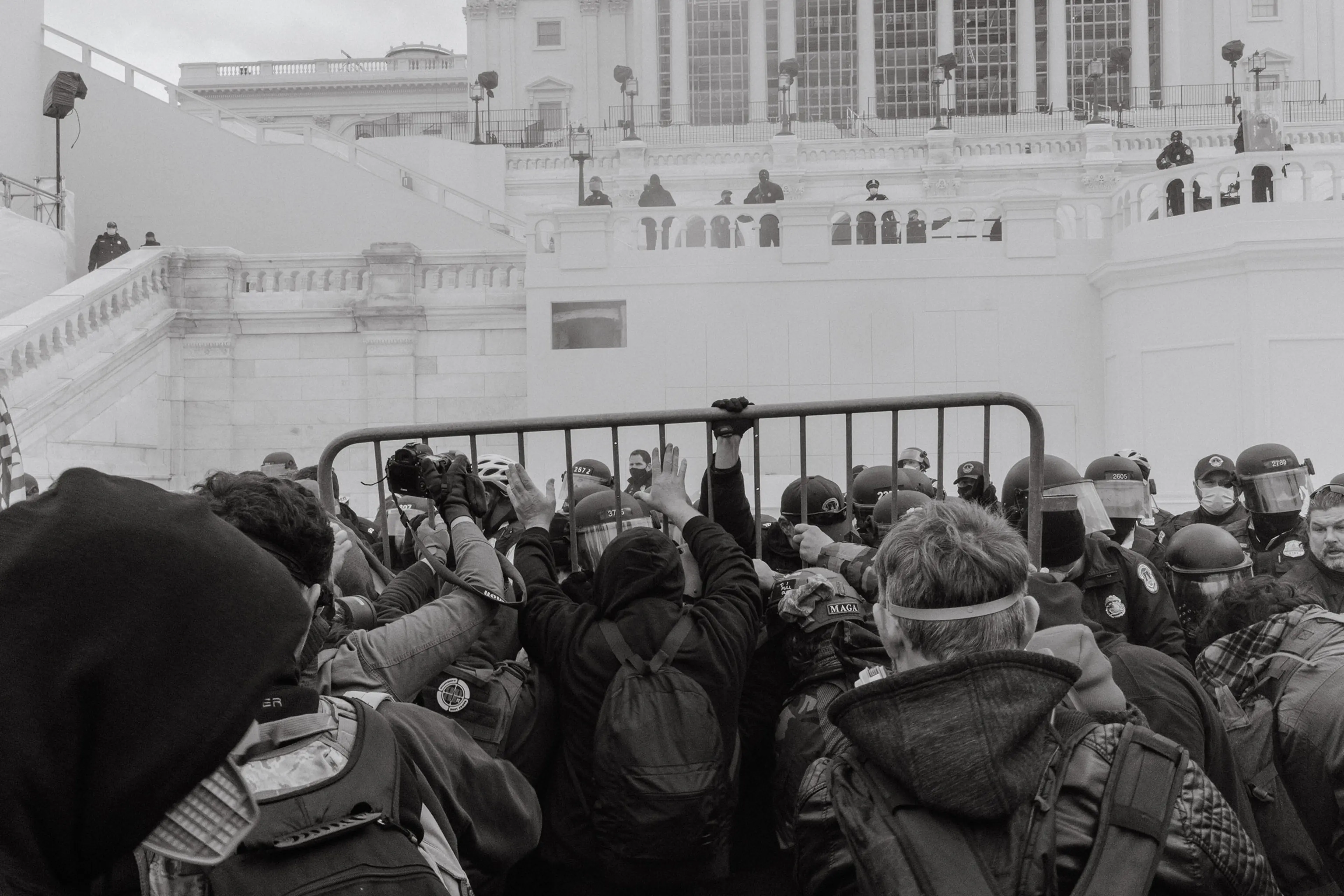Pro-Trump rioters attempt to move a barricade outside of the U.S. Capitol in Washington.