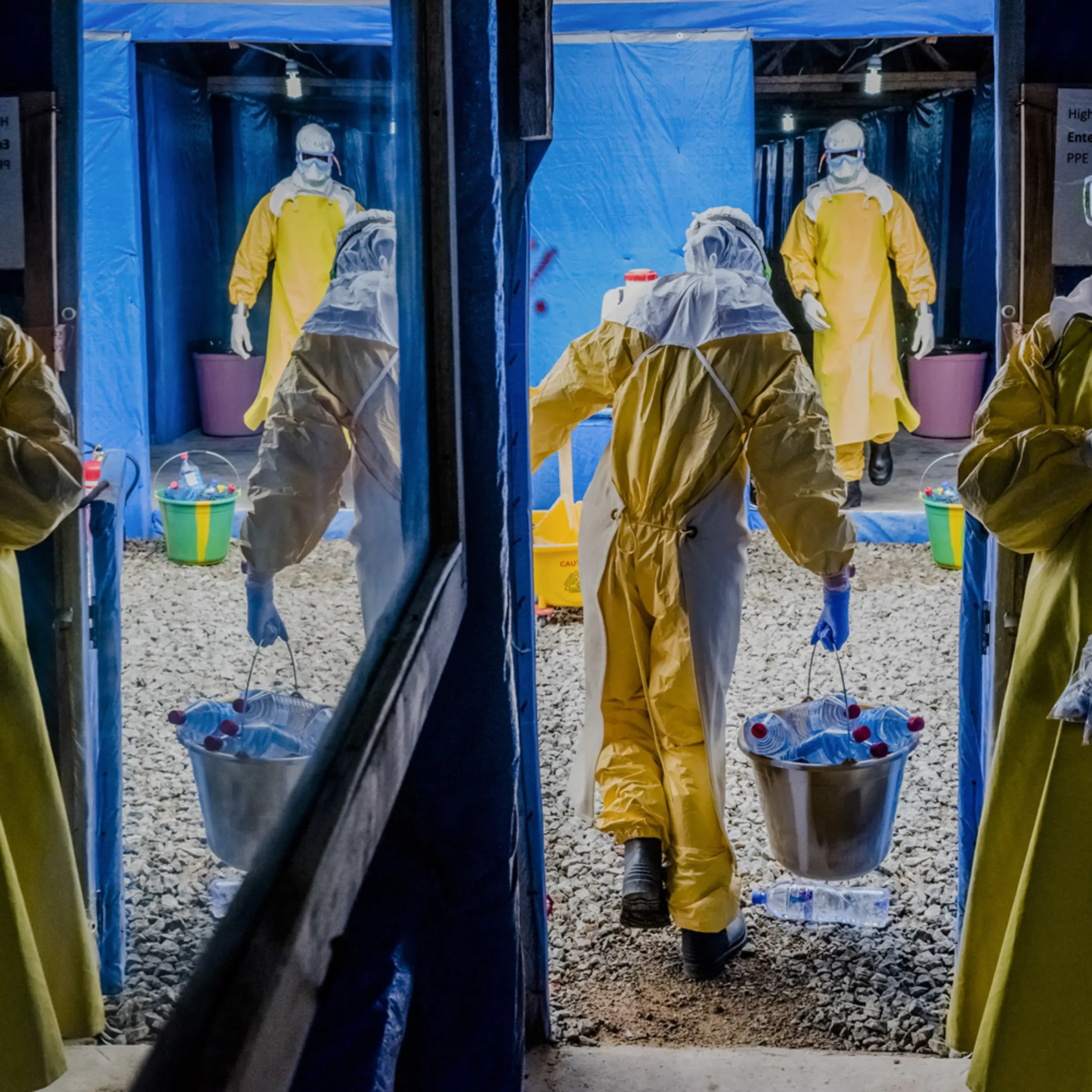 Health workers enter the high-risk zone as they make the morning rounds at the Bong County Ebola Treatment Unit in Sgt. Kollie Town near Gbarnga, Liberia, Oct. 6, 2014.