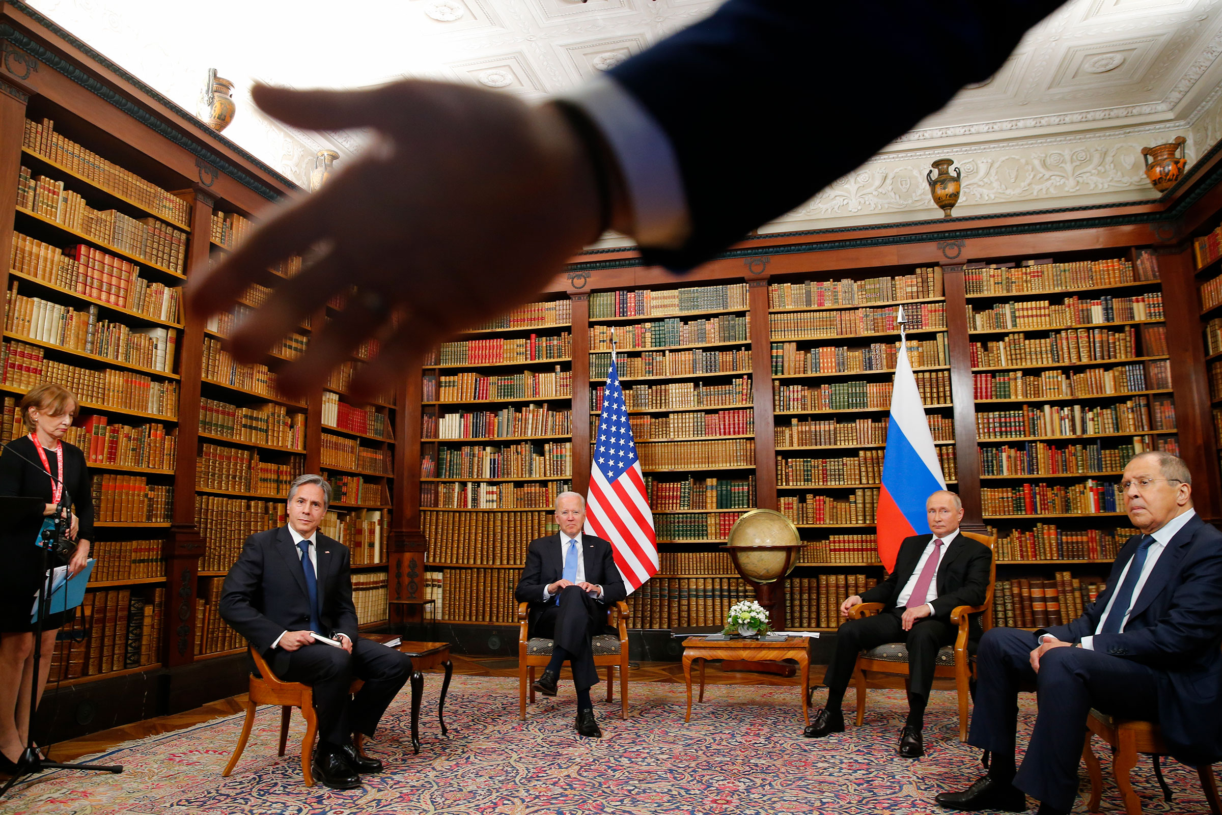A security officer indicates to the media to step back as U.S. President Joe Biden, second from left, U.S. Secretary of State Antony Blinken, left, Russia's President Vladimir Putin, second from right, and Russia's Foreign Minister Sergei Lavrov, right, 