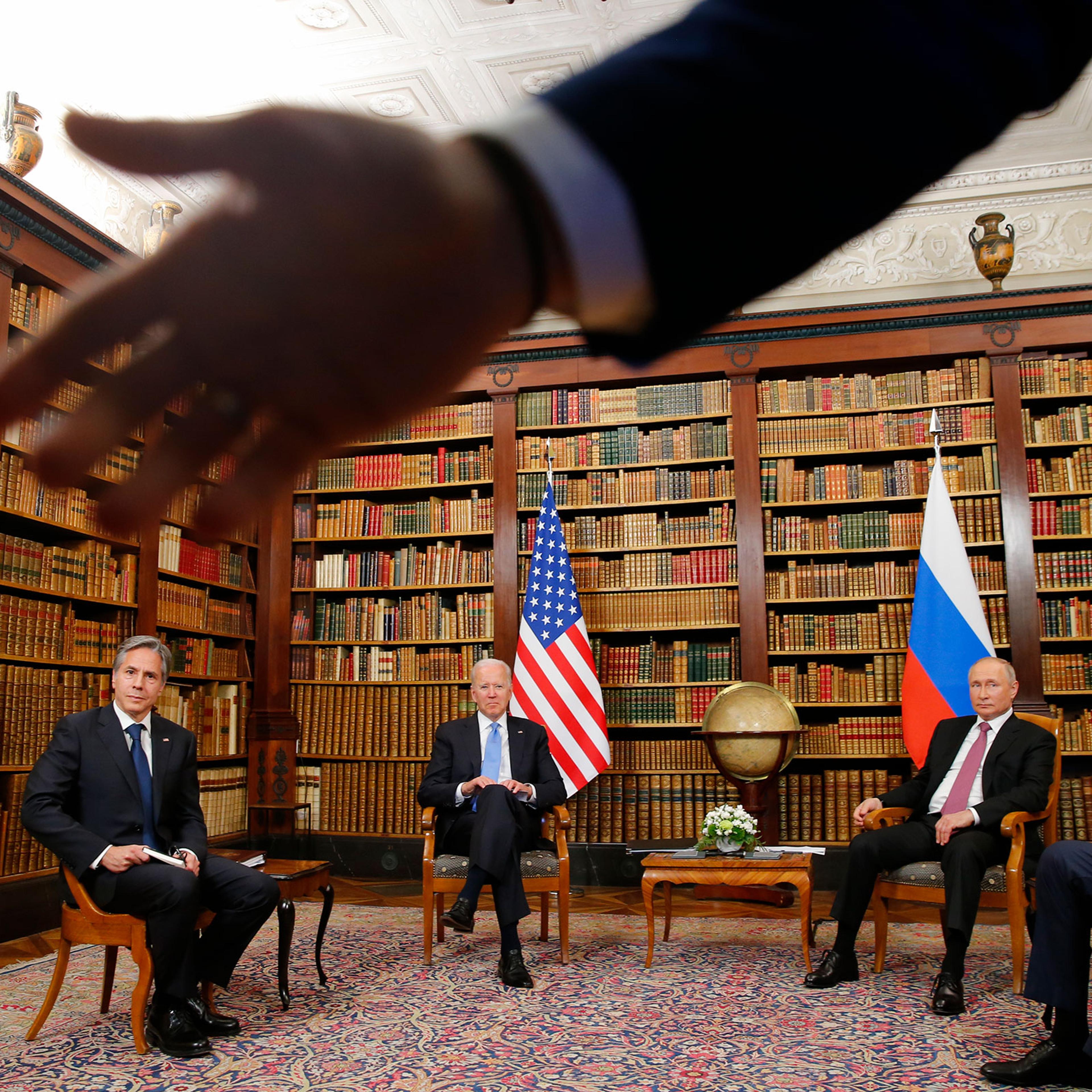 A security officer indicates to the media to step back as U.S. President Joe Biden, second from left, U.S. Secretary of State Antony Blinken, left, Russia's President Vladimir Putin, second from right, and Russia's Foreign Minister Sergei Lavrov, right,