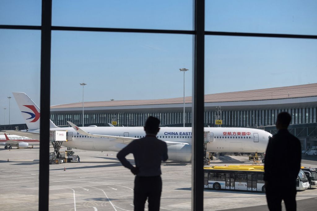 People watch a China Eastern plane as it prepares to take off from the Beijing Daxing International Airport on Sept. 25, 2019.