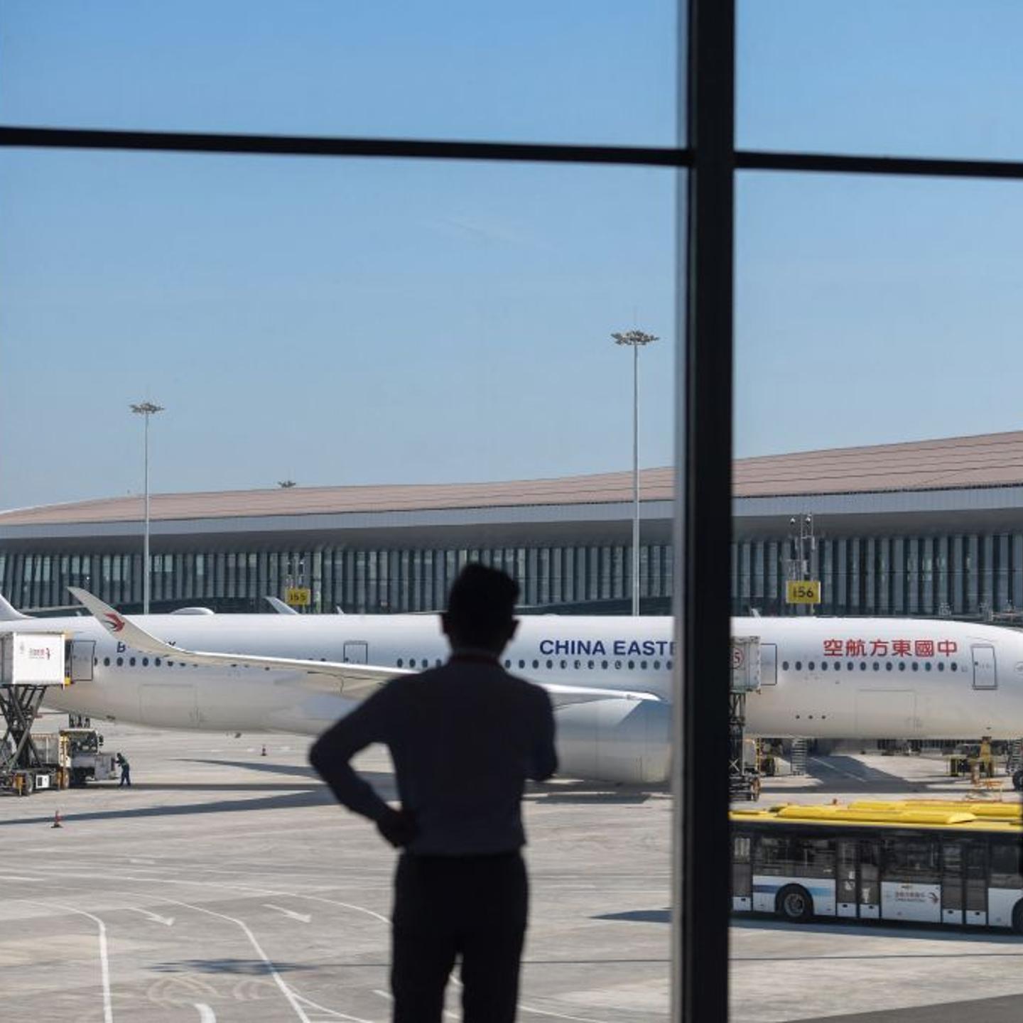 People watch a China Eastern plane as it prepares to take off from the Beijing Daxing International Airport on Sept. 25, 2019.