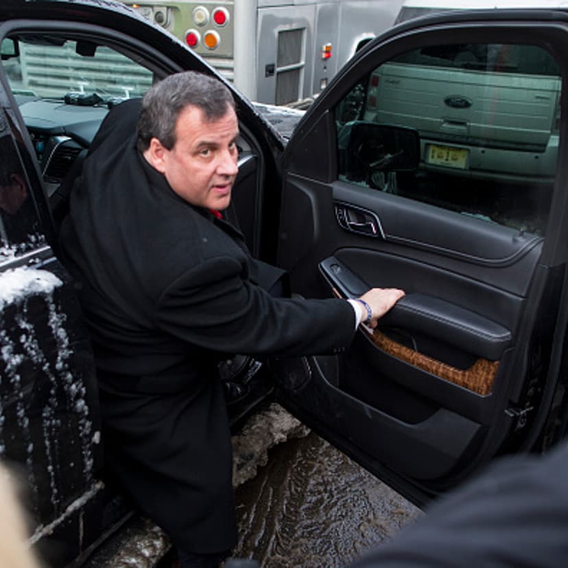 Republican presidential candidate New Jersey Governor Chris Christie exits his SUV outside the polling place at Webster School February 9, 2016 in Manchester, New Hampshire.