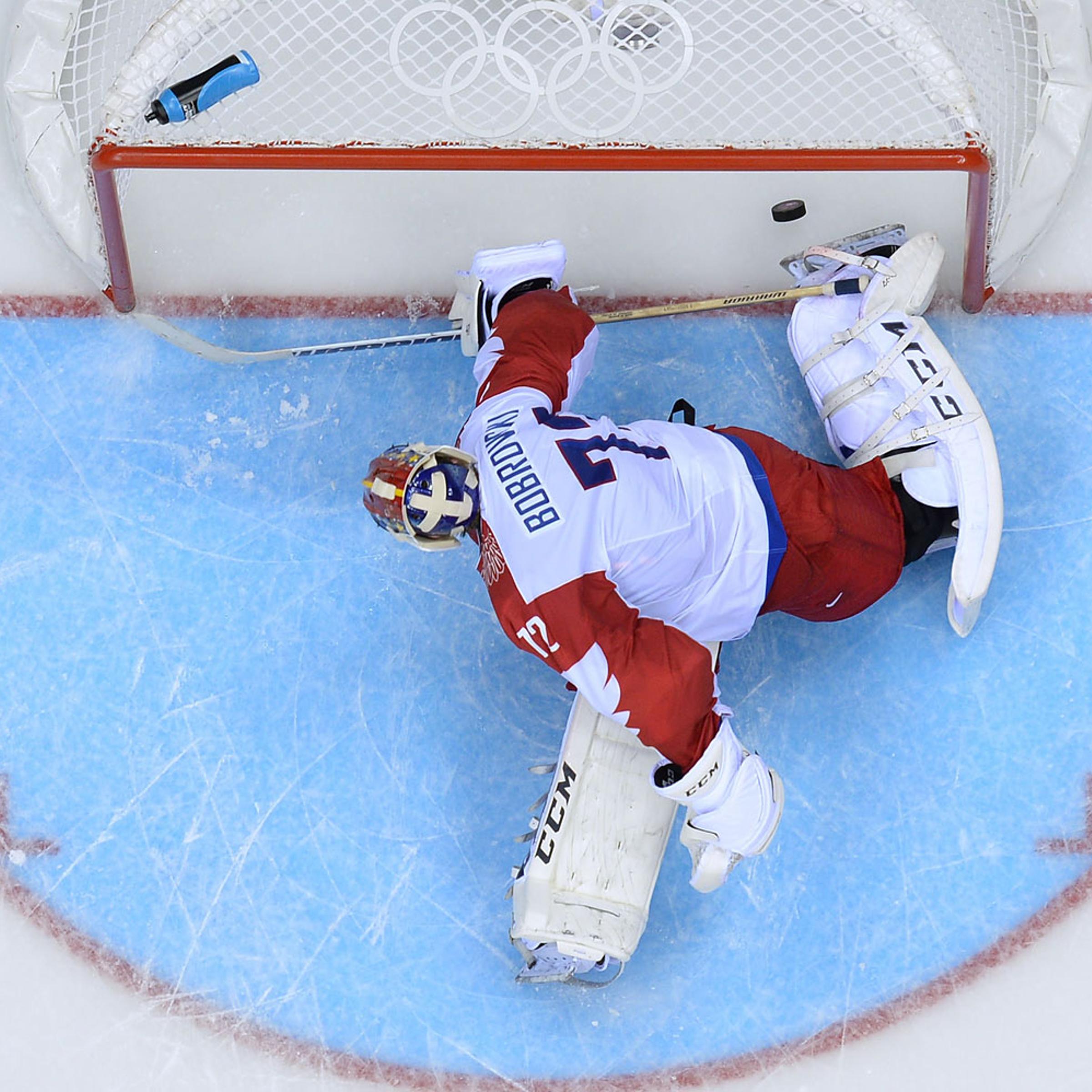 Russia's goalkeeper Sergei Bobrovski fails to stop a penalty during the Men's Ice Hockey Group A match USA vs Russia at the Bolshoy Ice Dome during the Sochi Winter Olympics on February 15, 2014 in Sochi.