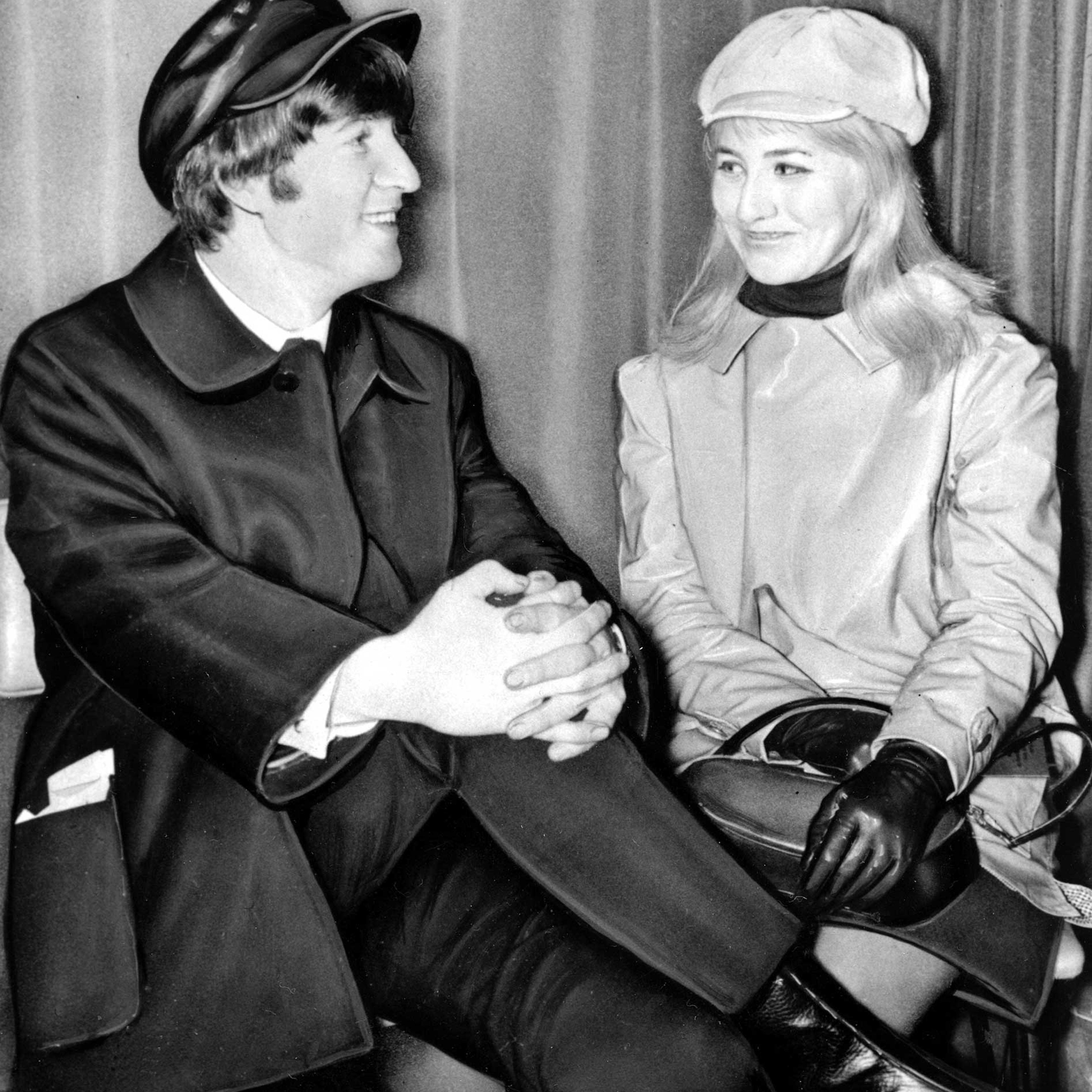 Beatle John Lennon and his wife, Cynthia, sit in London Airport, England, before flying to the U.S. on Feb. 7, 1964.