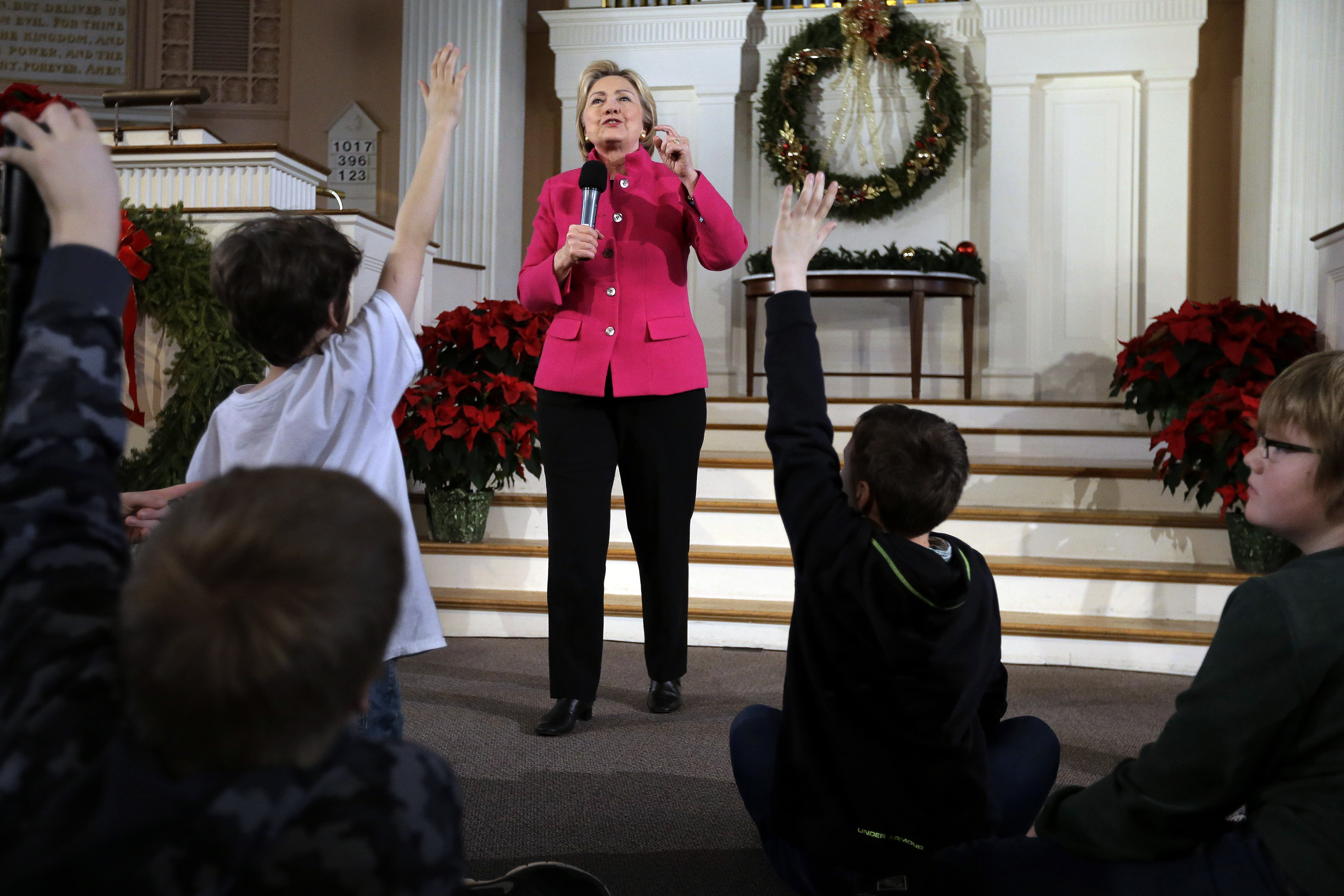 Democratic presidential candidate Hillary Clinton takes questions as children raise their hands during a town hall campaign event, Tuesday, Dec. 29, 2015, at South Church in Portsmouth, N.H.