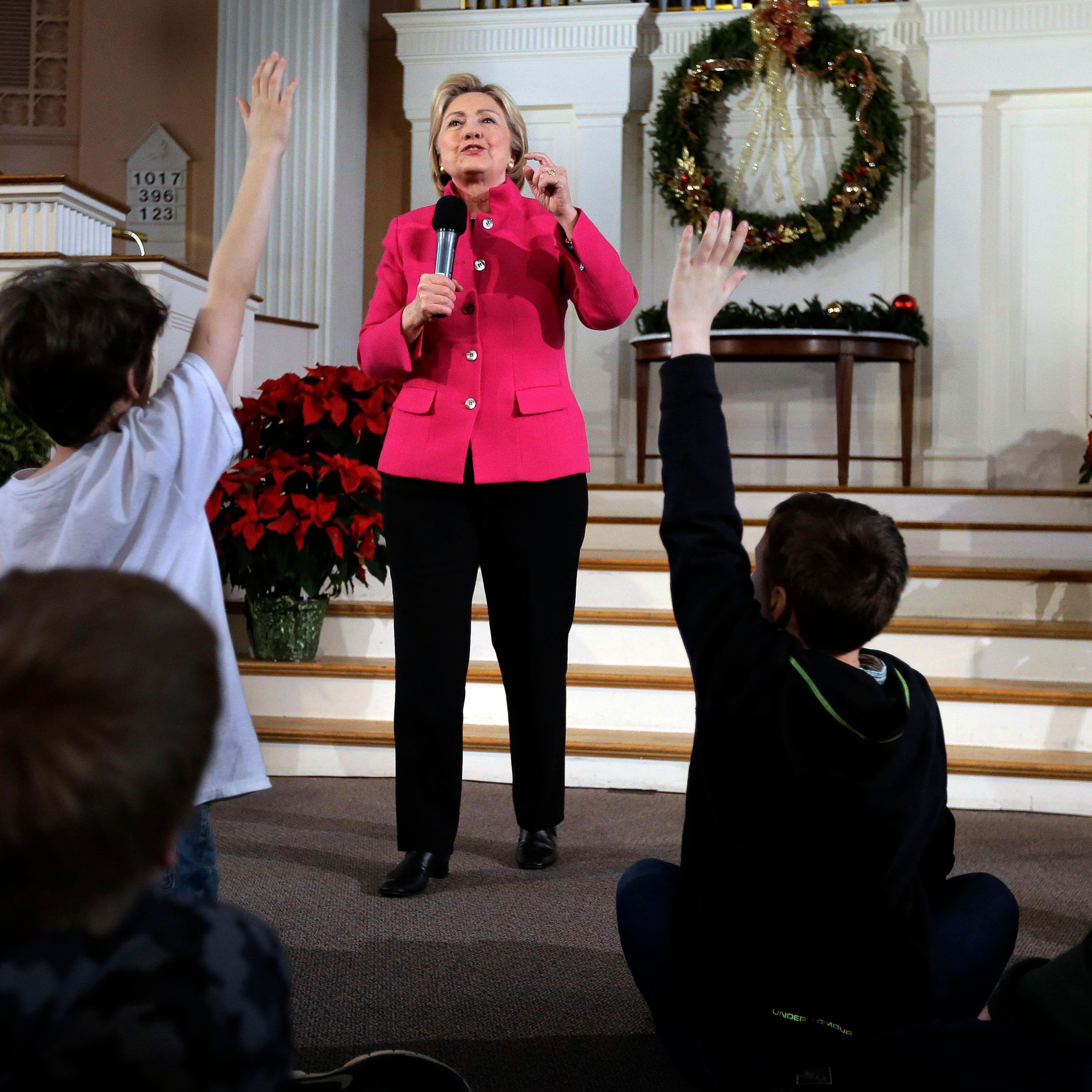 Democratic presidential candidate Hillary Clinton takes questions as children raise their hands during a town hall campaign event, Tuesday, Dec. 29, 2015, at South Church in Portsmouth, N.H.