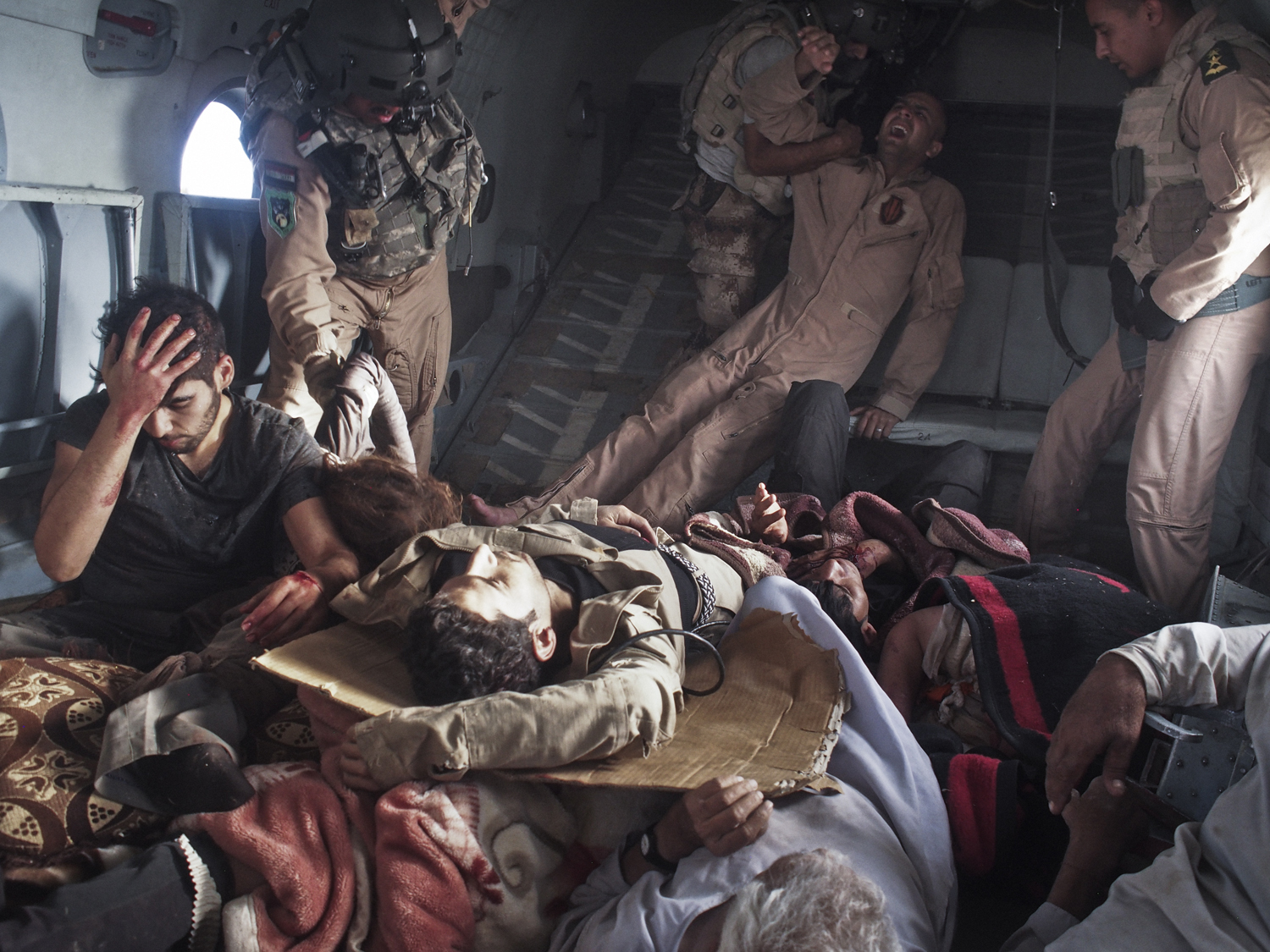 Sinjar Mountains, Iraq. August 12, 2014.Survivors of the crash, including yazidi refugees and Kurdish and Iraqi Army personnel, onboard a rescue helicopter that transported them from the crash site back to Kurdish-controlled Dohuk Province. An Iraqi Air 
