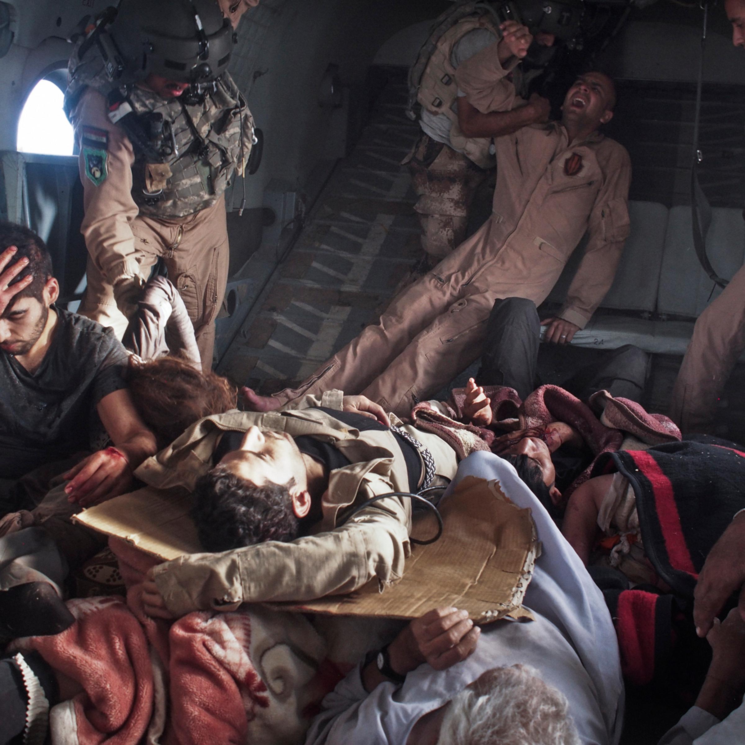 Sinjar Mountains, Iraq. August 12, 2014.Survivors of the crash, including yazidi refugees and Kurdish and Iraqi Army personnel, onboard a rescue helicopter that transported them from the crash site back to Kurdish-controlled Dohuk Province. An Iraqi Air