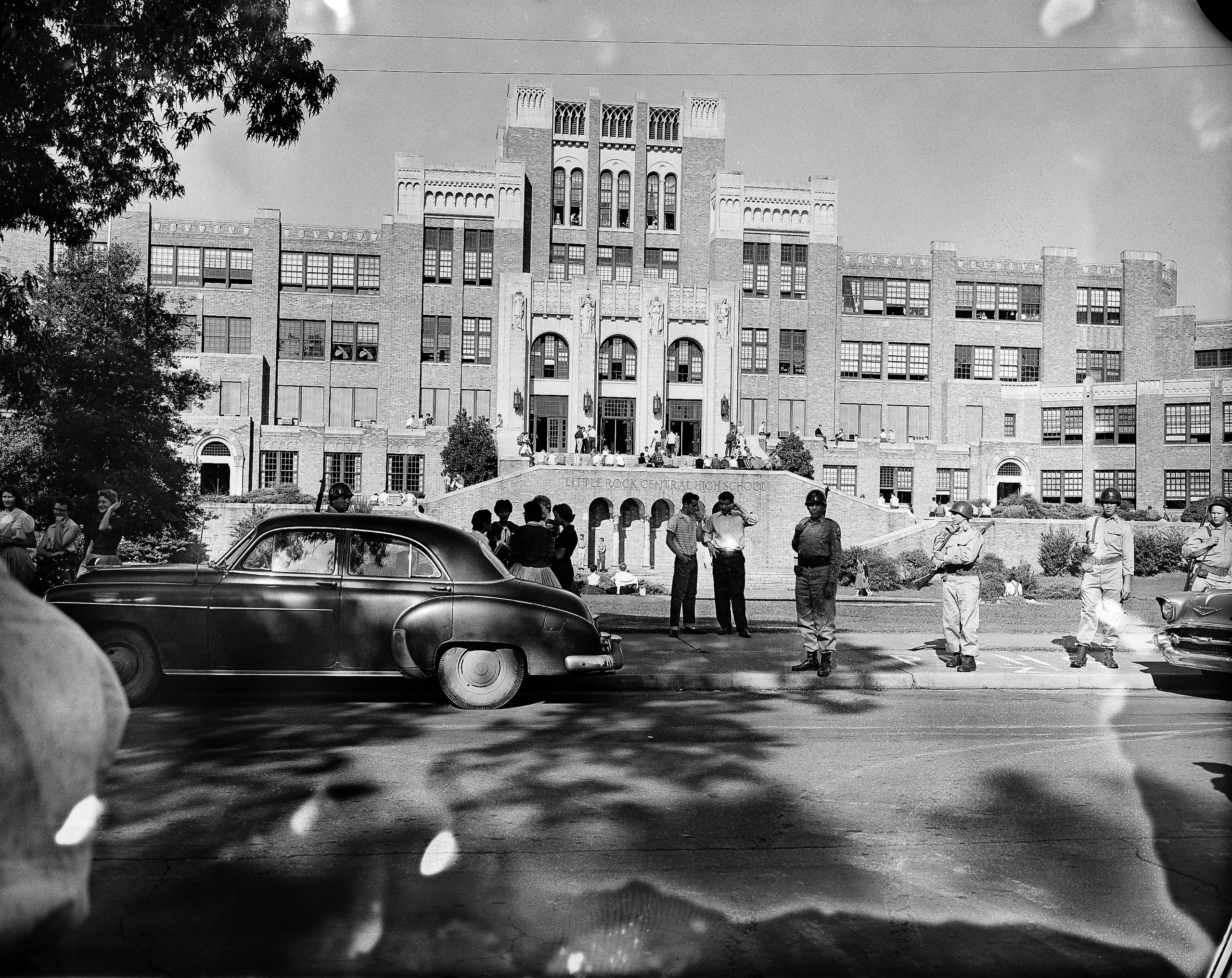 Only a small crowd of people gather in front of Little Rock Central High School the morning of Sept. 16, 1957. There were no incidents, with no black students trying to enter the school. Gov. Orval Faubus has kept guardsmen around the building for more t
