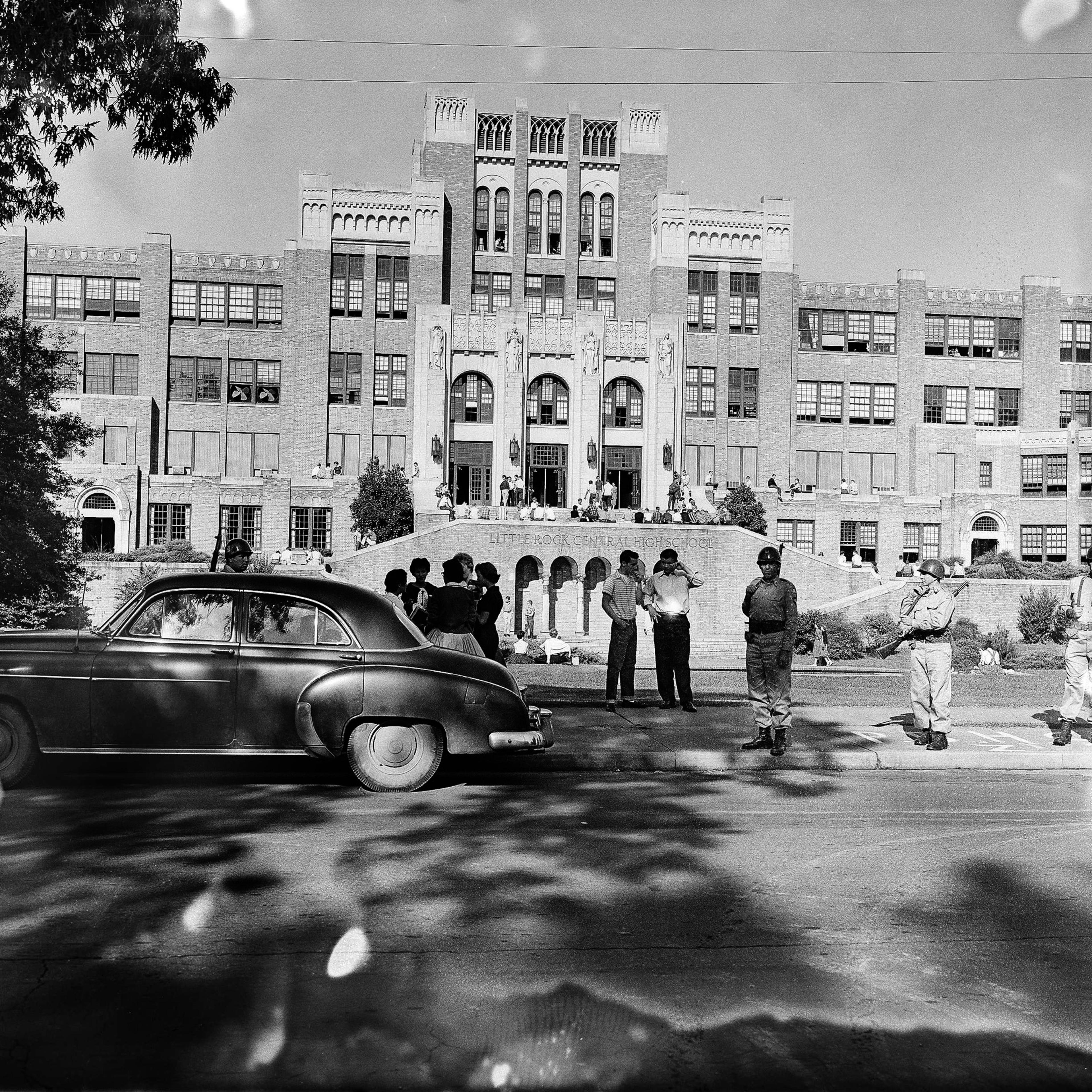 Only a small crowd of people gather in front of Little Rock Central High School the morning of Sept. 16, 1957. There were no incidents, with no black students trying to enter the school. Gov. Orval Faubus has kept guardsmen around the building for more t