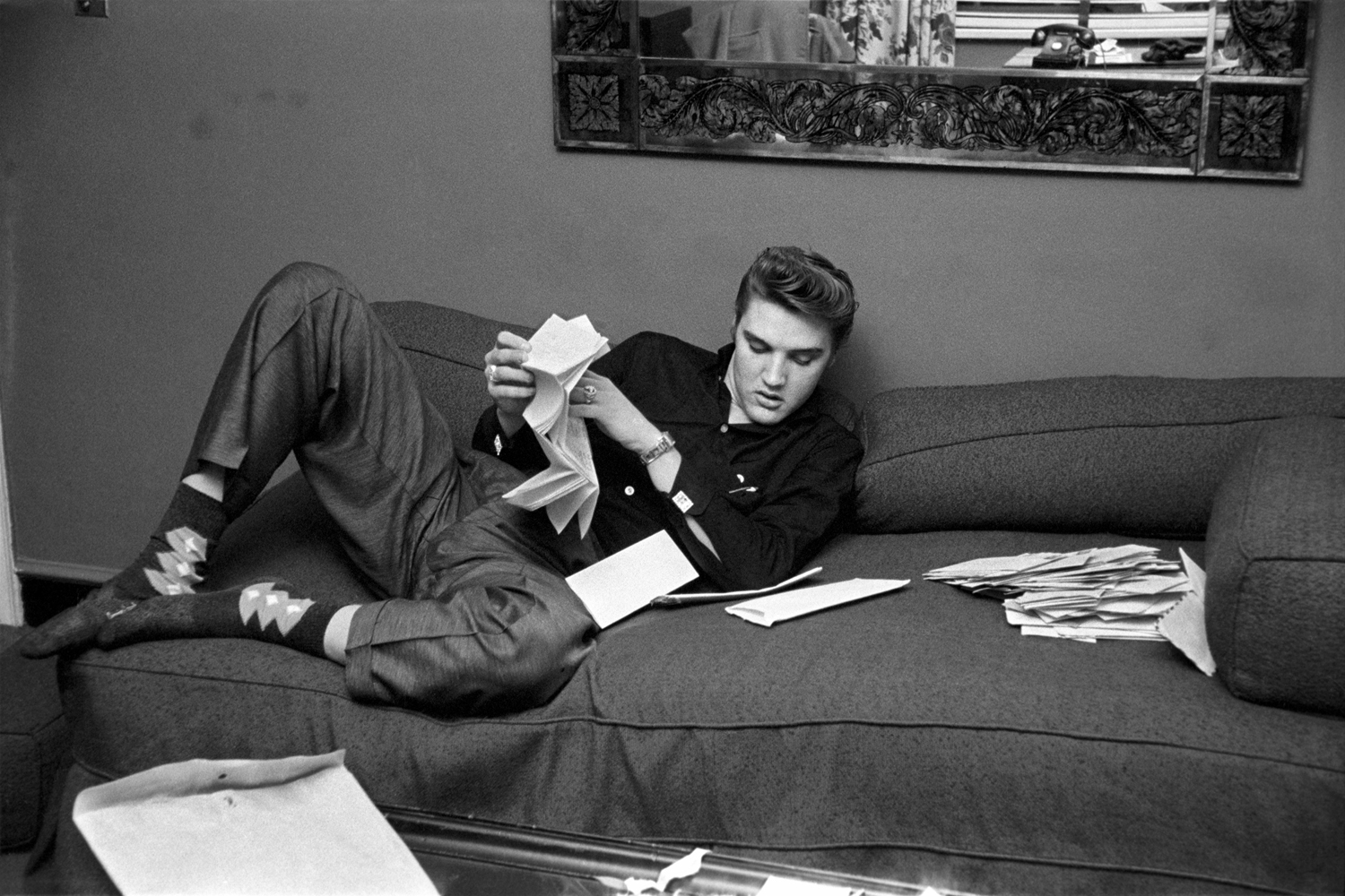 March 17, 1956. The Warwick, New York. We got into his room and there was an envelope on the couch with about a hundred letters from fans inside. He plopped down on the couch, pulled his shoes off (exposing his argyle socks) and proceeded to read some of the fan mail. Some letters were six or seven pages long and he was going to read every page. After he finished reading them, he tore them up, explaining "I don't want anyone else reading my mail and I'm not taking it with me."