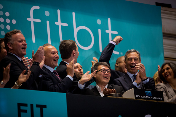 Fitbit Chief Executive James Park (C) rings the bell for the company's IPO debut at the New York Stock Exchange on June 18, 2015.