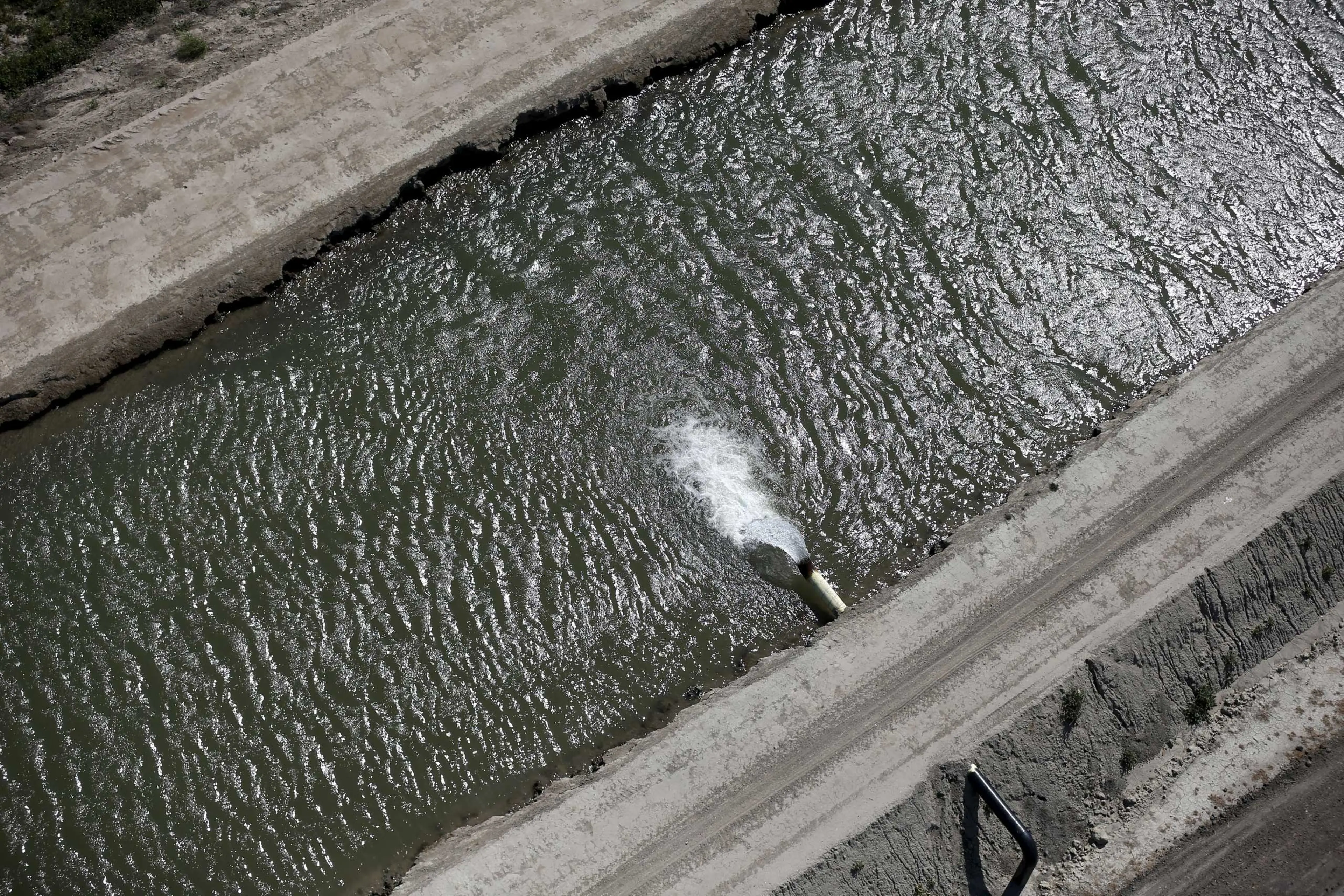Water pours into a canal in Los Banos