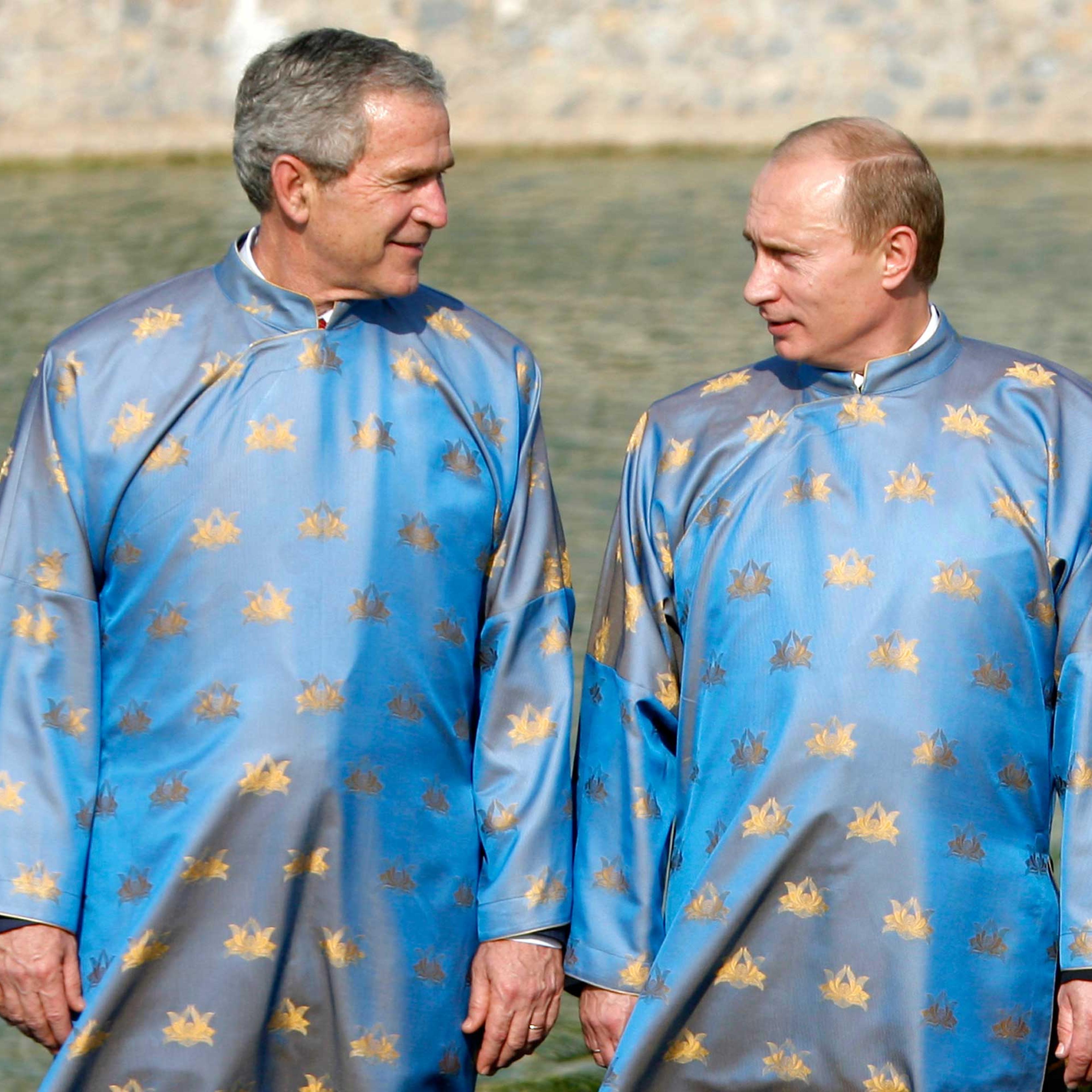 U.S. President George W. Bush talks with and Russian President Vladimir Putin during the official photograph for the APEC Summit in Hanoi