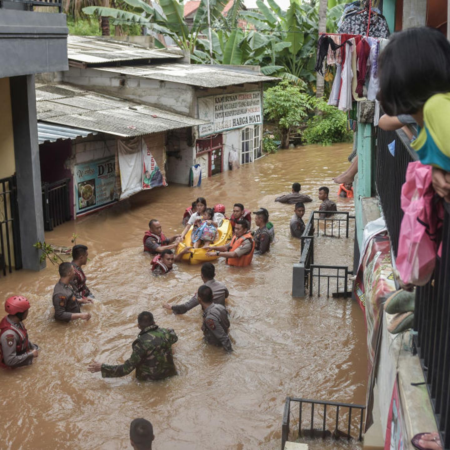 A rescue team evacuates residents from their flooded houses