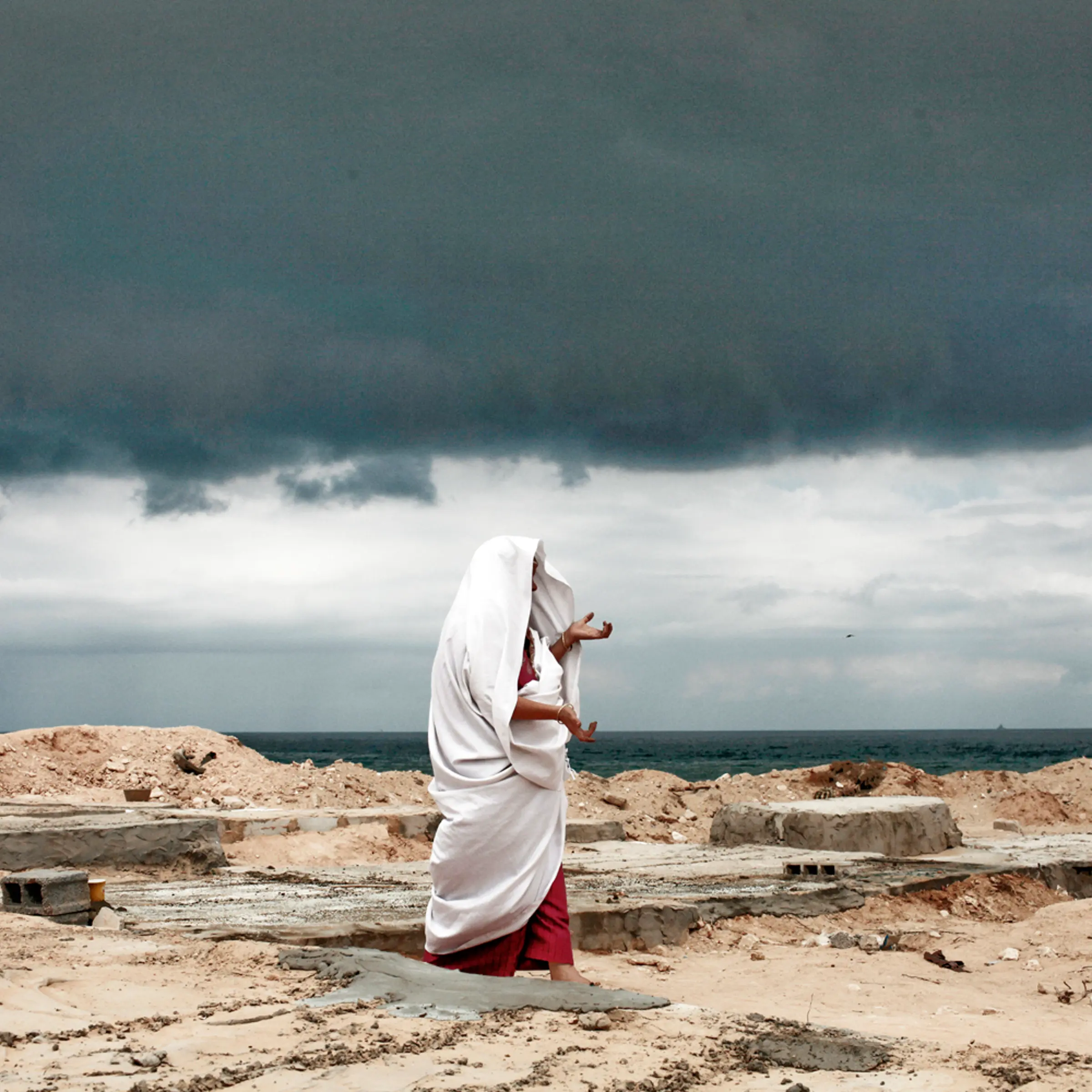 September 9, 2011. Under an ominous sky, Eyadea Elspaie visits the gravesite of his son, Tareq Elspaie, who was killed by Gafhafi loyalists last month, at a cemetery in Tripoli. Libyan rebels launched attacks on the loyalist holdouts of Bani Walid and Surt, and Interpol issued an arrest warrant for Col. Moammar Gadhafi.
