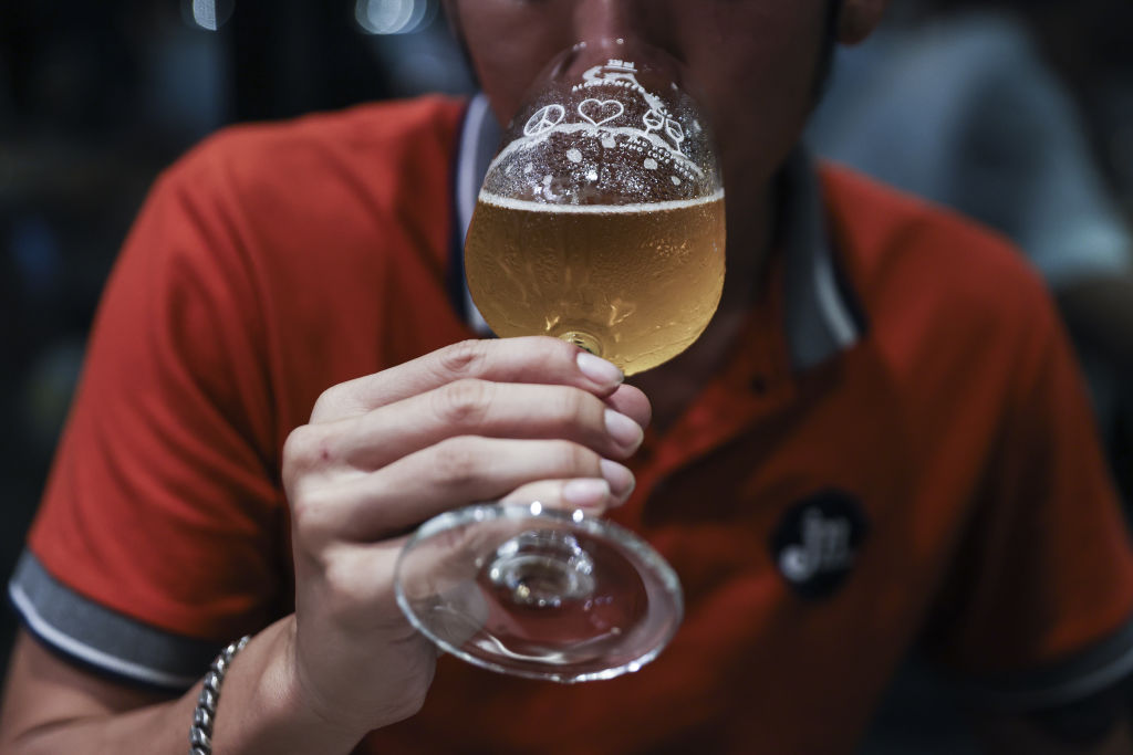 A customer drinks beer inside the United Peoples Brewery in Bangkok, Thailand, on Wednesday, July 26, 2023.