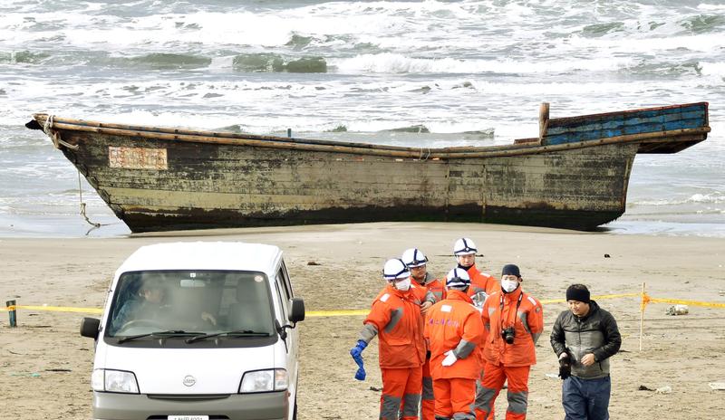 A wooden boat, which drifted ashore with eight partially skeletal bodies and was found by the Japan Coast Guard, is seen in Oga, Akita Prefecture, Japan