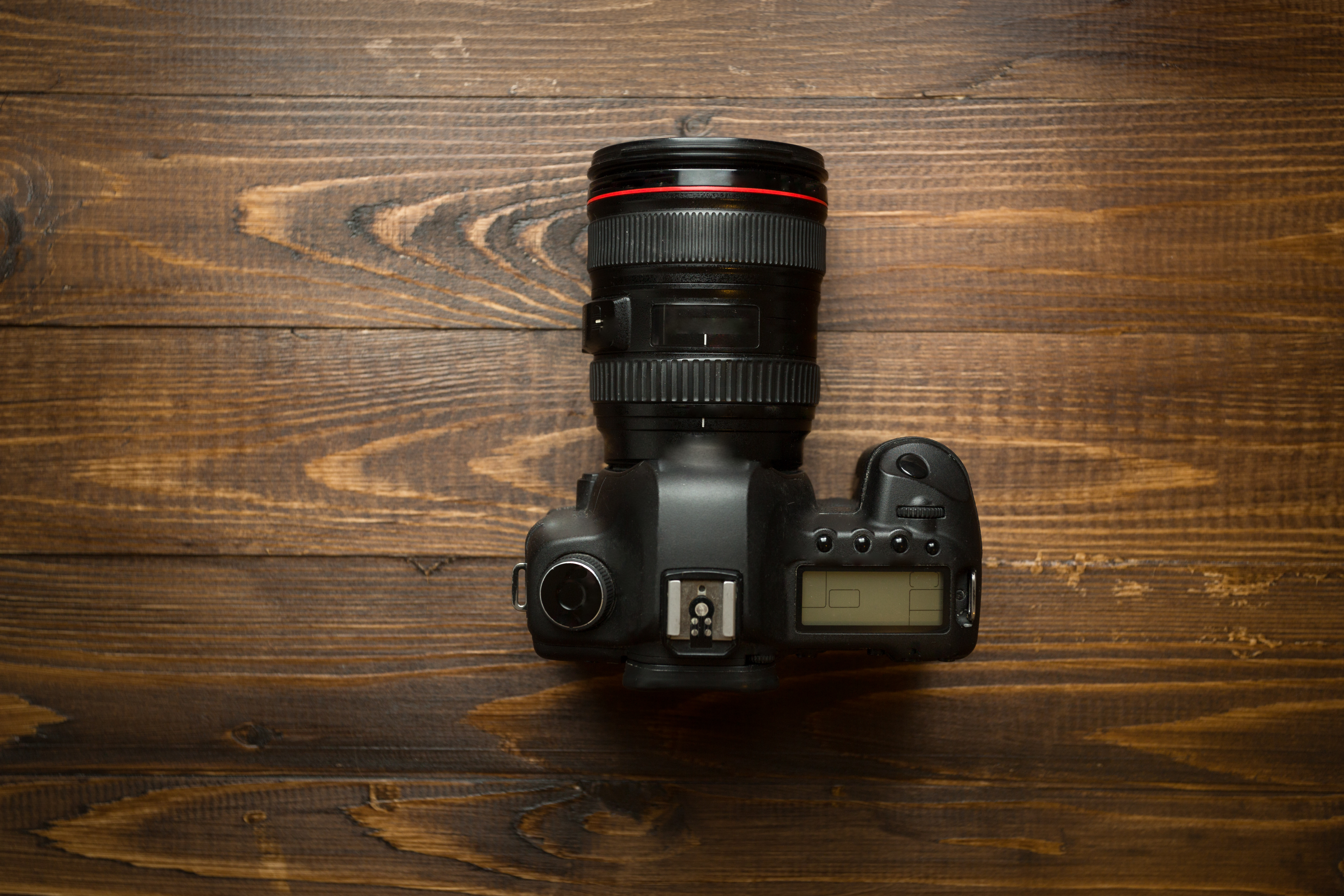 Professional digital camera on wooden background