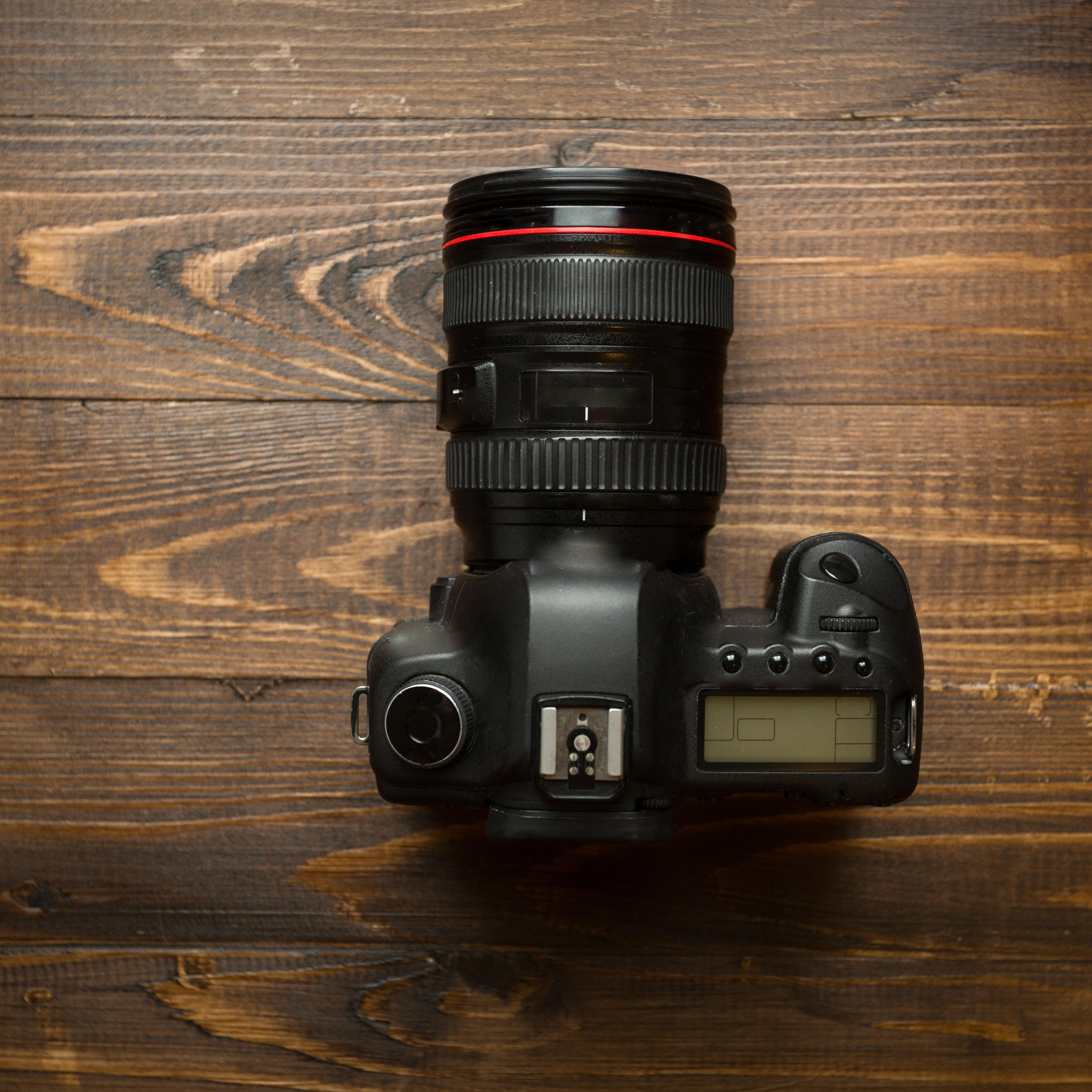 Professional digital camera on wooden background