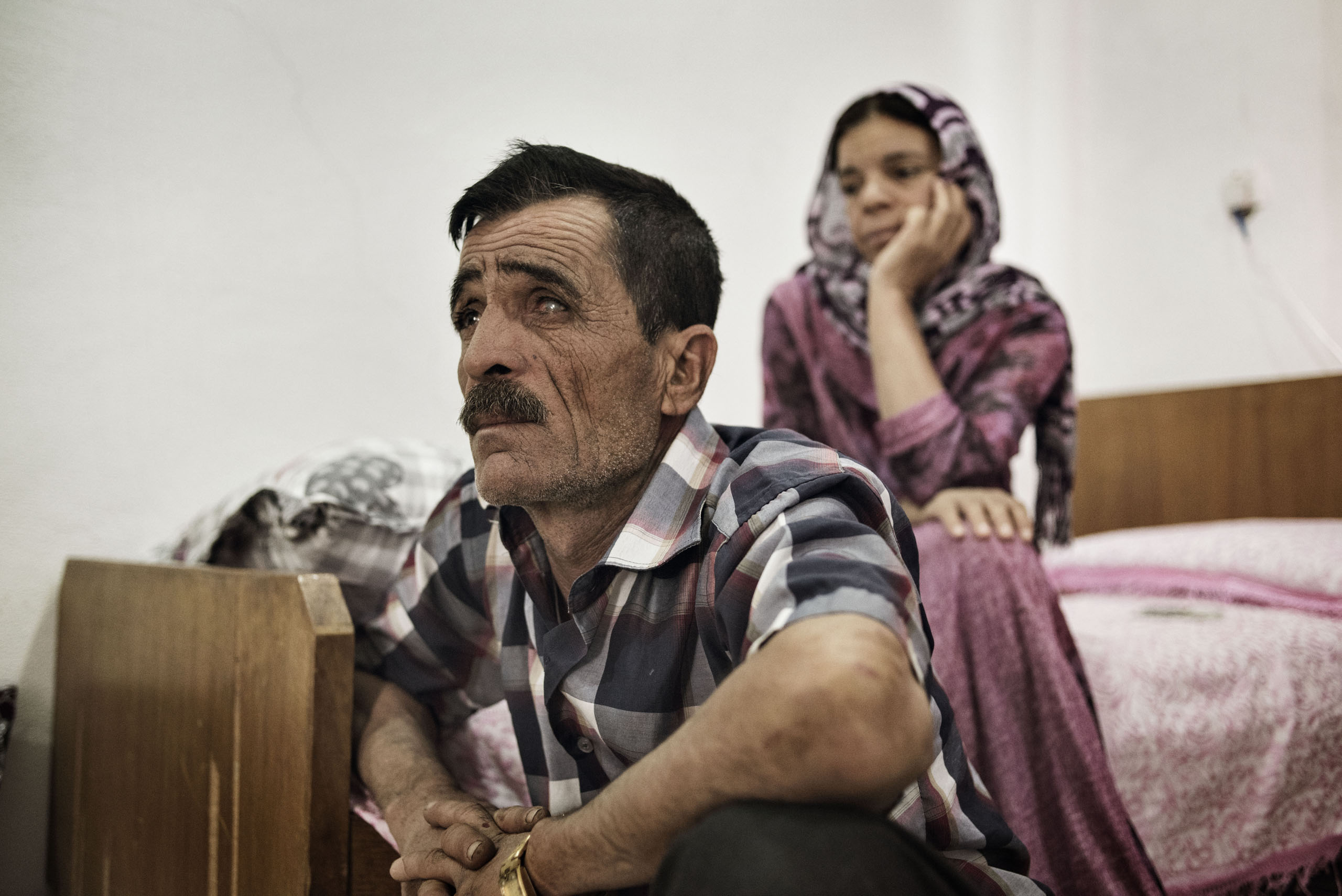 Khero Elias Khalad, 50, sits in an apartment in the Iraqi town of Sinjar, May 13, 2016. Khalaf fled with his family when ISIS fighters overran the town in August 2014. A shopkeeper, he has returned to live in Sinjar since it was recaptured by Kurdish arm