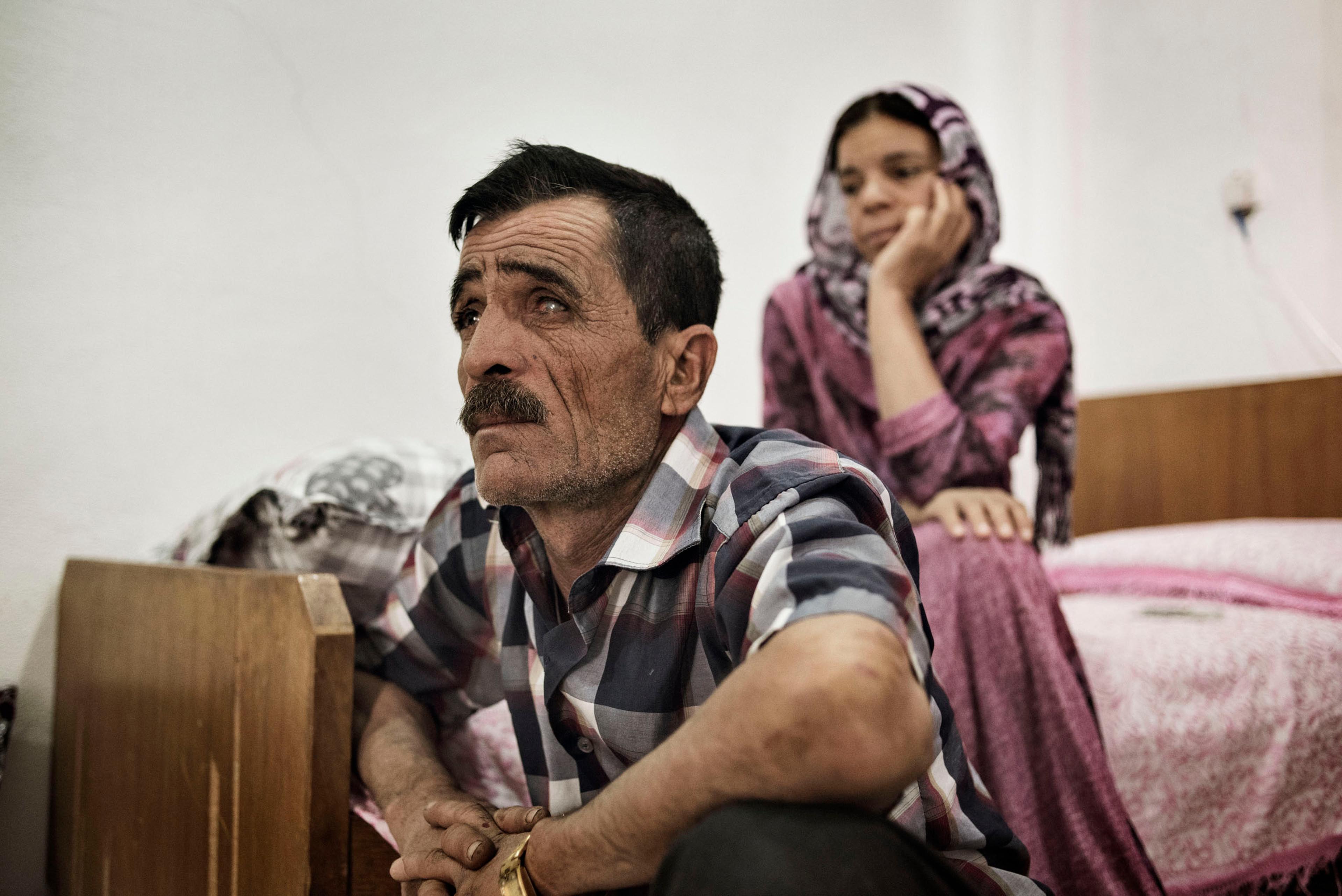 Khero Elias Khalad, 50, sits in an apartment in the Iraqi town of Sinjar, May 13, 2016. Khalaf fled with his family when ISIS fighters overran the town in August 2014. A shopkeeper, he has returned to live in Sinjar since it was recaptured by Kurdish arm