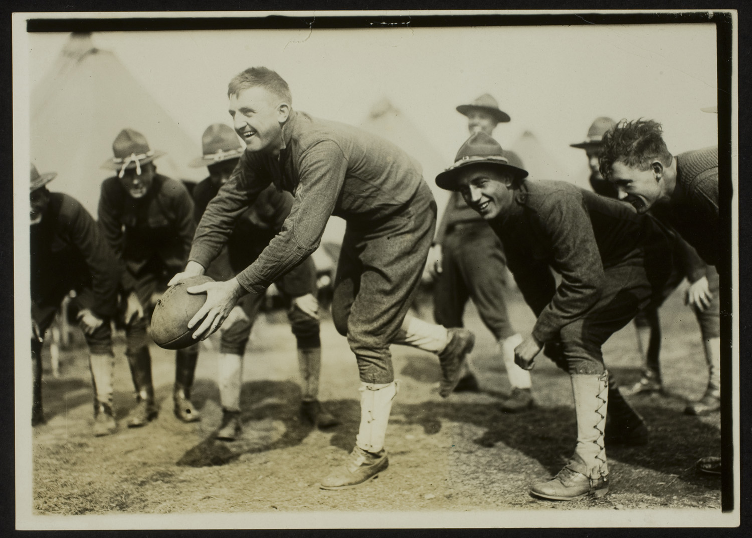 Soldiers playing football, Army training camp, 1917