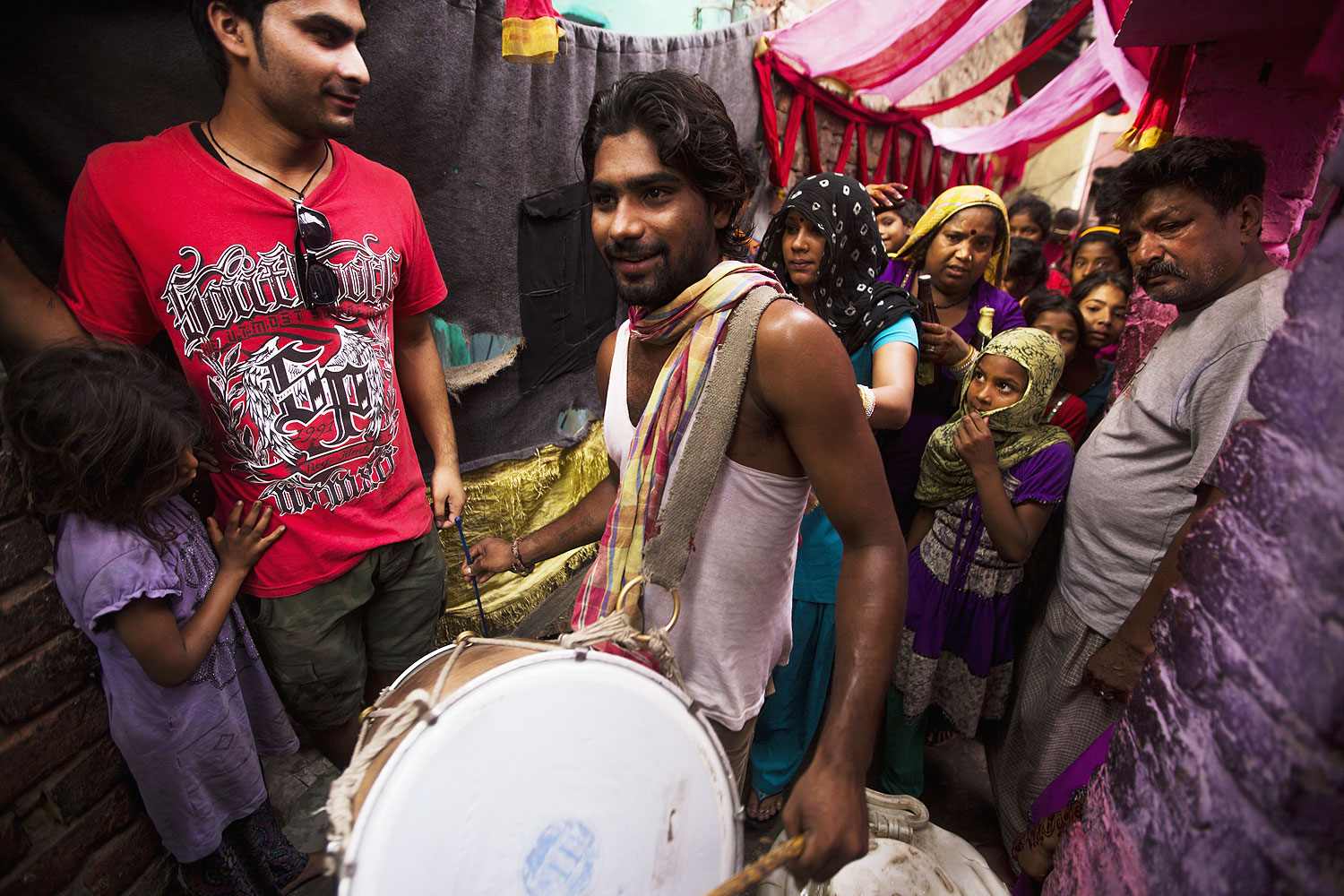 An Indian drummer leads a group of women during a wedding procession in Kathputli Colony in New Delhi, June 2013. The name Kathputli Colony comes from the Hindi word for puppet, and it is an area inhabited by puppeteers, magicians, acrobats, dancers and musicians