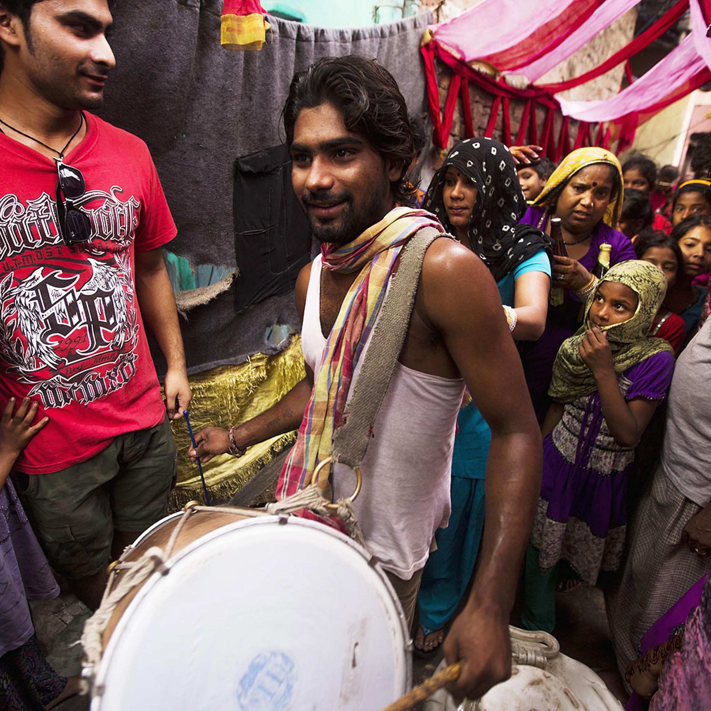 An Indian drummer leads a group of women during a wedding procession in Kathputli Colony in New Delhi, June 2013. The name Kathputli Colony comes from the Hindi word for puppet, and it is an area inhabited by puppeteers, magicians, acrobats, dancers and musicians