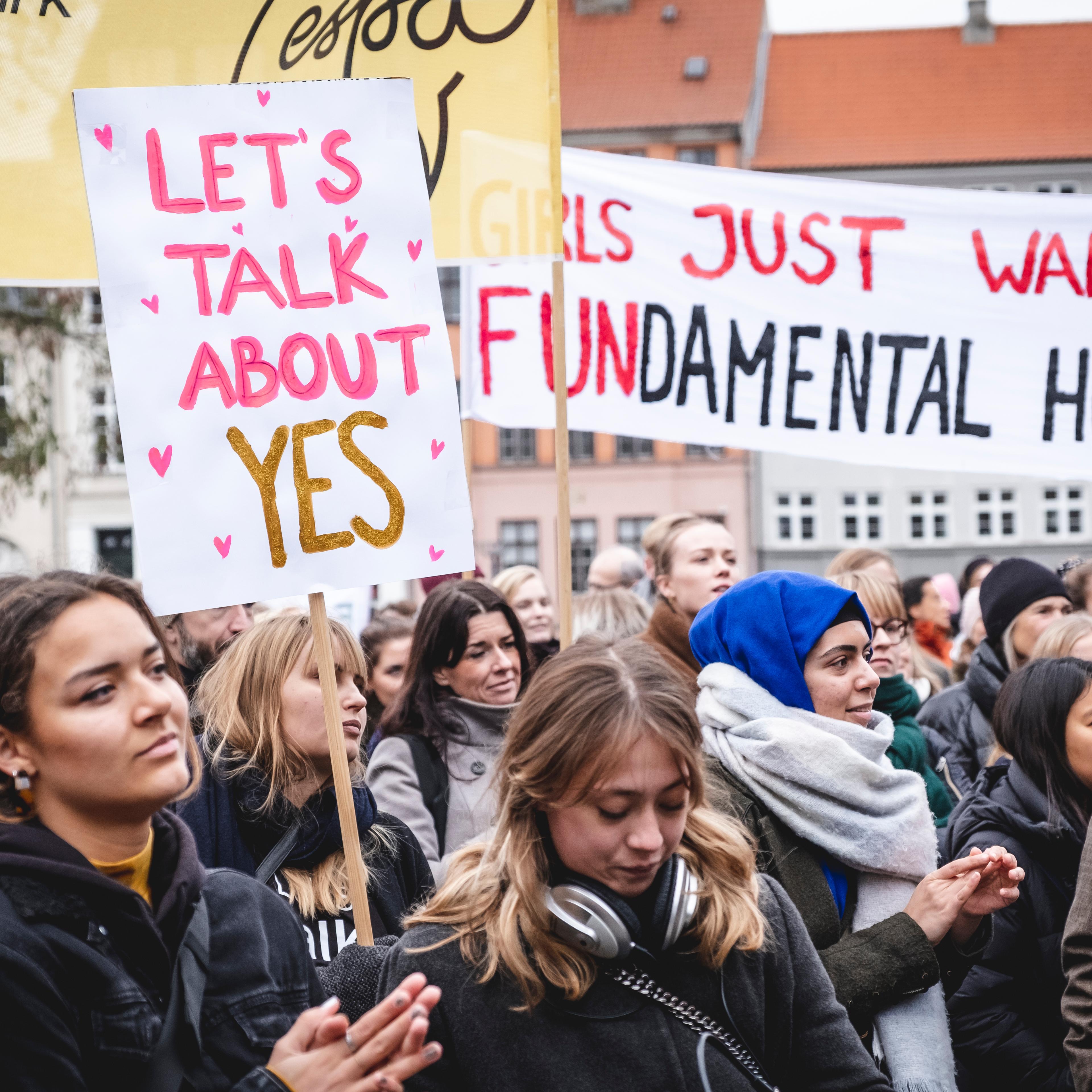 Women attend a "Let's Talk About Yes' protest in Denmark.